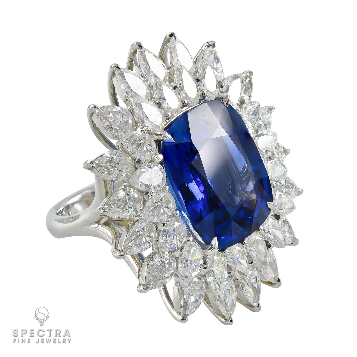 A gorgeous cocktail ring embellished with a 15.67 carat cushion-shaped blue sapphire and diamonds.
The sapphire is accompanied by a report from C. Dunaigre lab, stating that it is of Ceylon origin with the indication of heating.  
The double halo