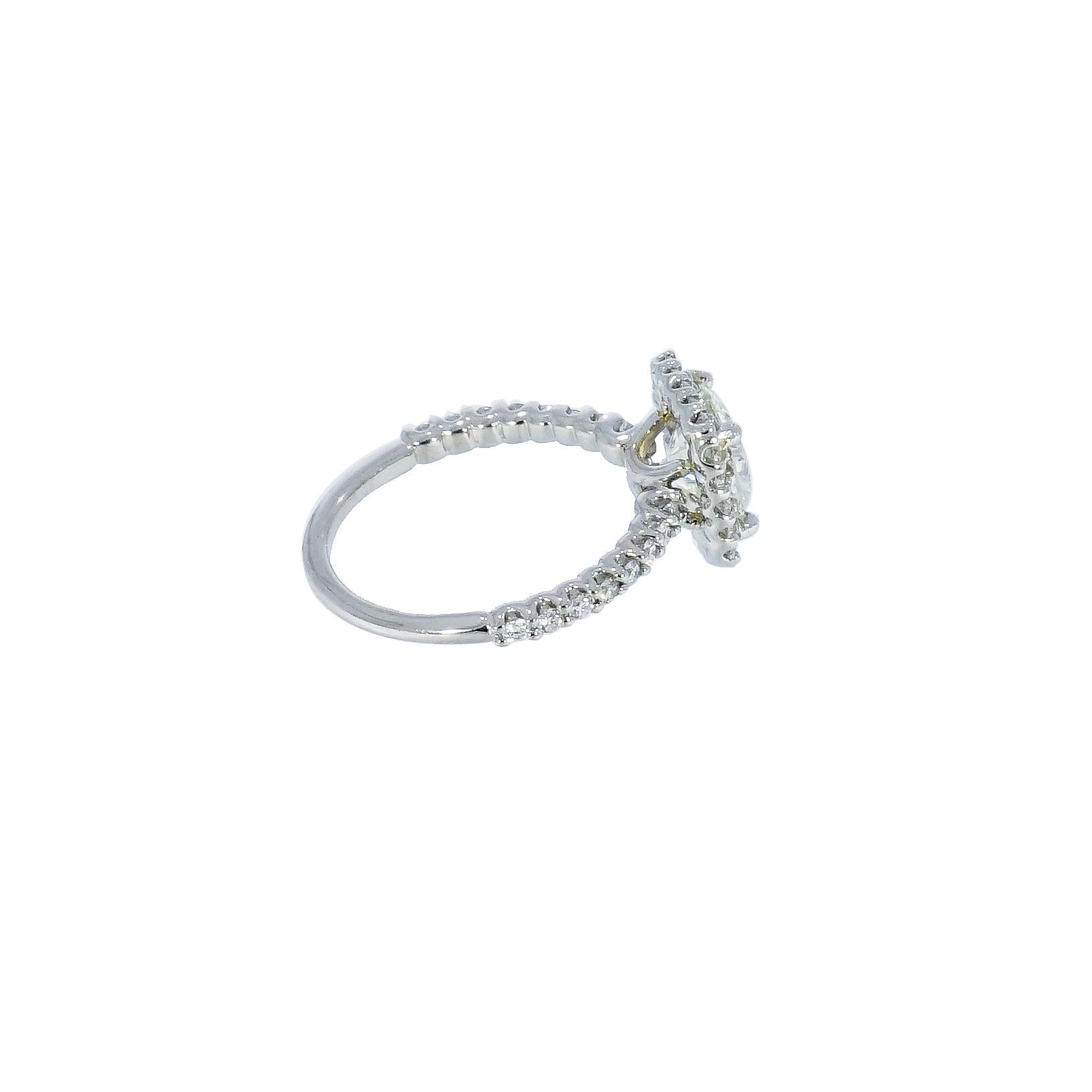 This gorgeous and feminine cushion shaped halo engagement ring includes a 1.58 carat Round Diamond center, J color, SI1 clarity, certified by EGL. 
The Platinum ring features a line of shimmering, round brilliant cut diamonds down both sides,