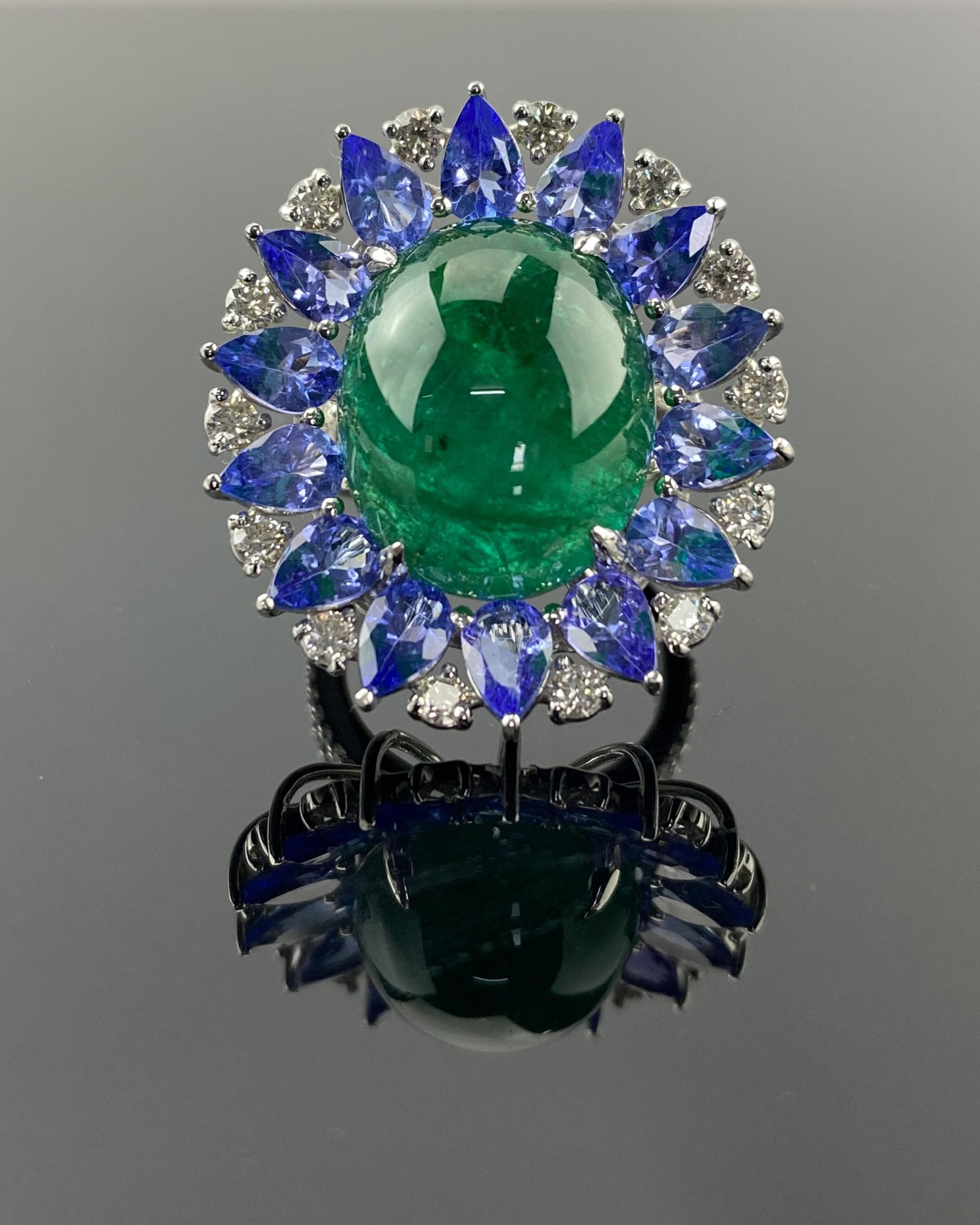 A beautiful combination of 16.62 carat oval Emerald Cabochon, 5.19 carat pear shape Tanzanite and 0.99 carat Diamond cocktail ring, set in solid 18K White Gold.
The ring is made in solid 18K White Gold, currently sized at US 7, can be resized. 
We