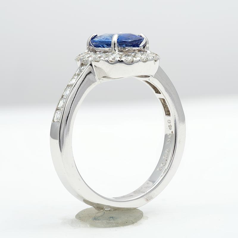 Behold this natural and untreated certified Sapphire, its allure derived from its pristine state. The mesmerizing ocean blue hue is captivating to all who behold it. Meticulously handcrafted in 14K white gold, this ring features a halo of diamonds