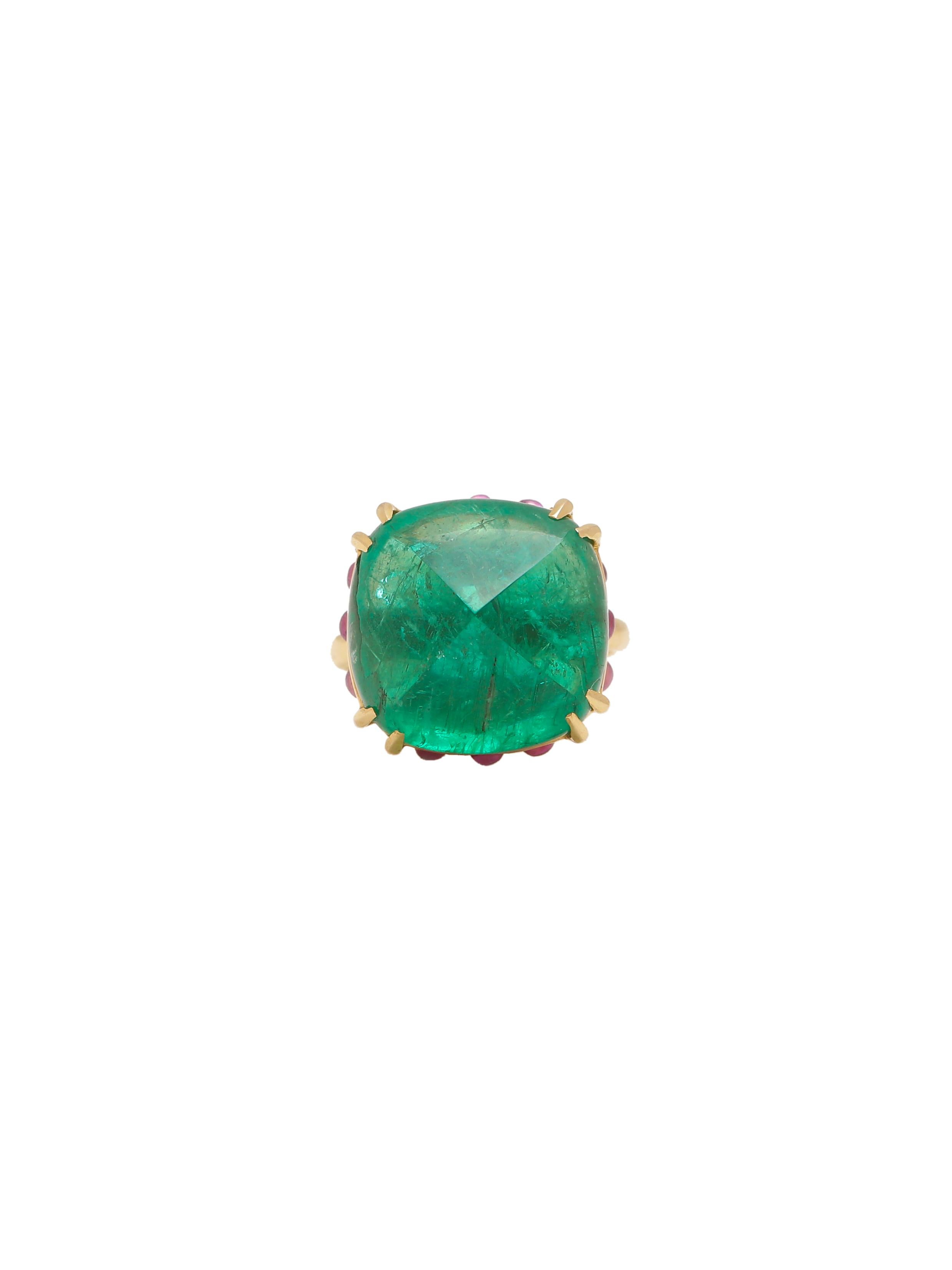 A beautiful ring with a Emerald Cabochon Sugarloaf in the centre and Round Ruby Cabochons carefully set under the stone giving the stone the height and making it stand out as it deserves. The Emerald comes from the famous Zambian mines and is a very