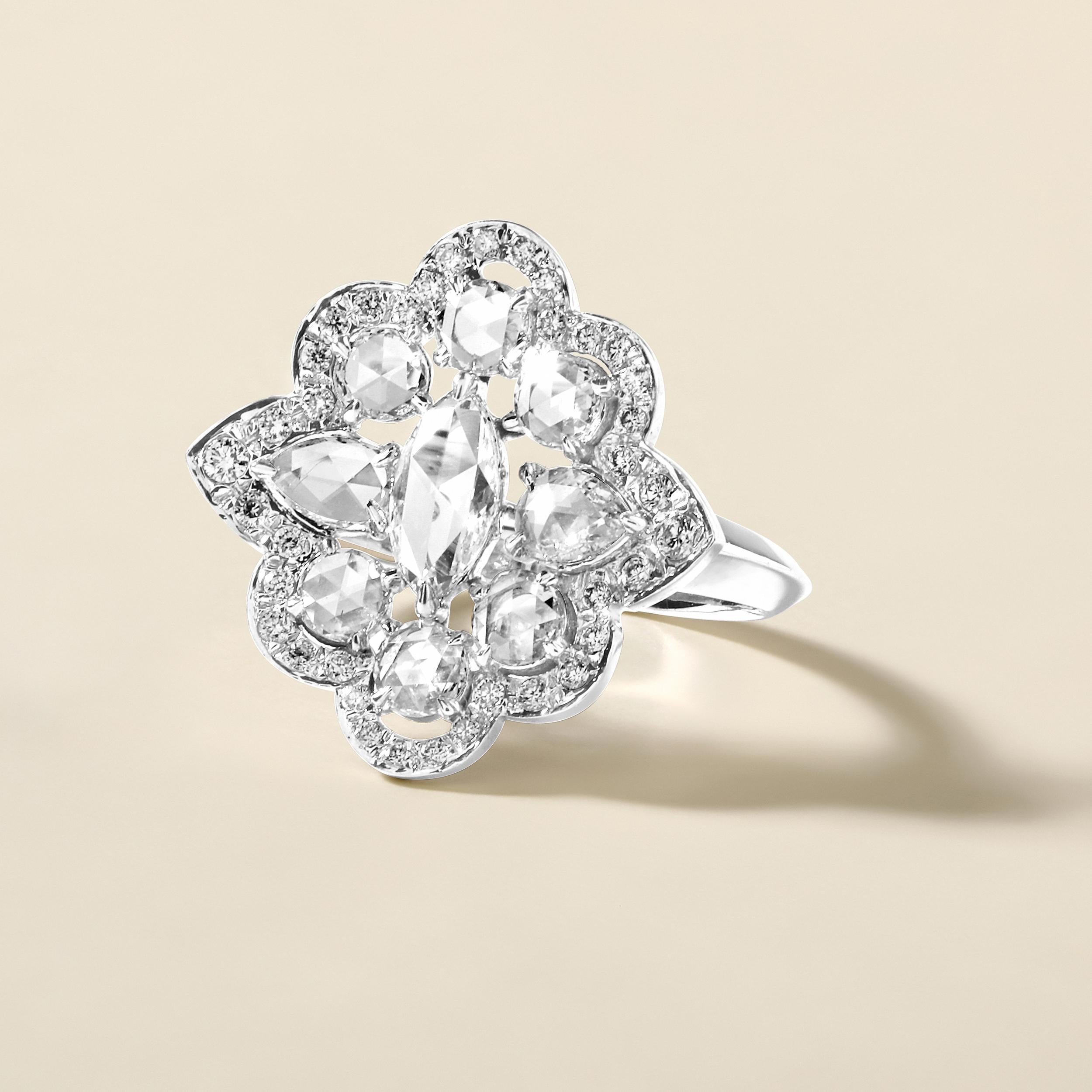 Ring Size: US 7

Crafted in 4.52 grams of 18K White Gold, the ring contains 9 stones of Rose Cut Natural Diamonds with a total of 0.89 carat in F-G color and VVS-VS clarity combined with 37 stones of Round Natural Diamonds with a total of 0.19 carat
