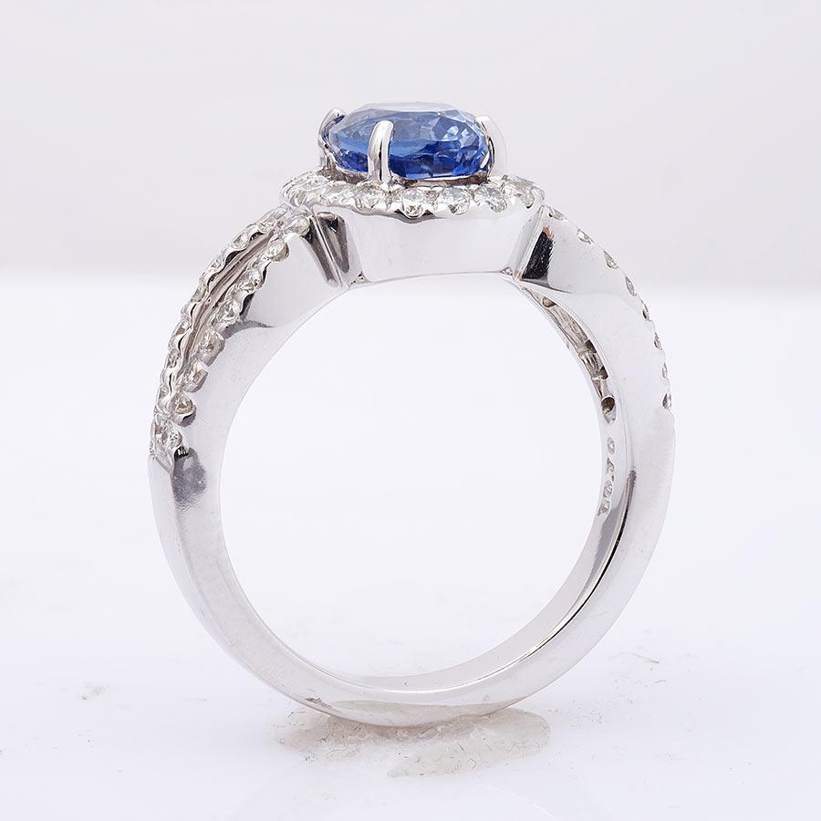 Captivating with its soothing purplish-blue hue, this 1.99 carats natural Sapphire is a mesmerizing gem that complements any skin tone. Nestled at the center and embraced by a halo of diamonds, it holds a unique and irreplaceable charm, much like