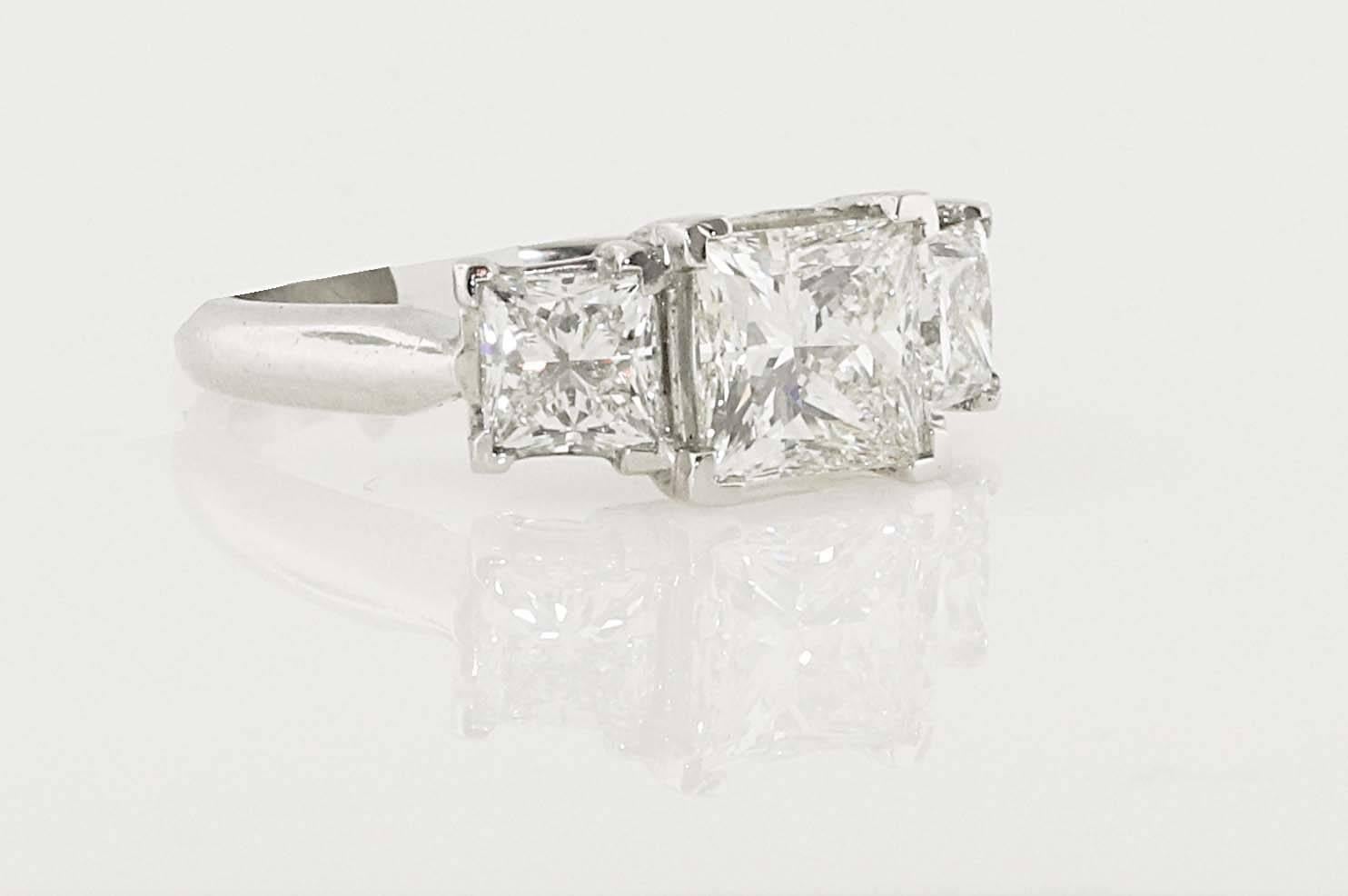 Spectacular 3 stone certified Princess Cut diamond ring set in platinum. The center princess cut diamond is 2.01 i-vs2 EGL USA certified and the sides are .77 G-Si1 EGL USA certified and .78 F-VS2 EGL USA certified. 

Ring is a size 6 but can be