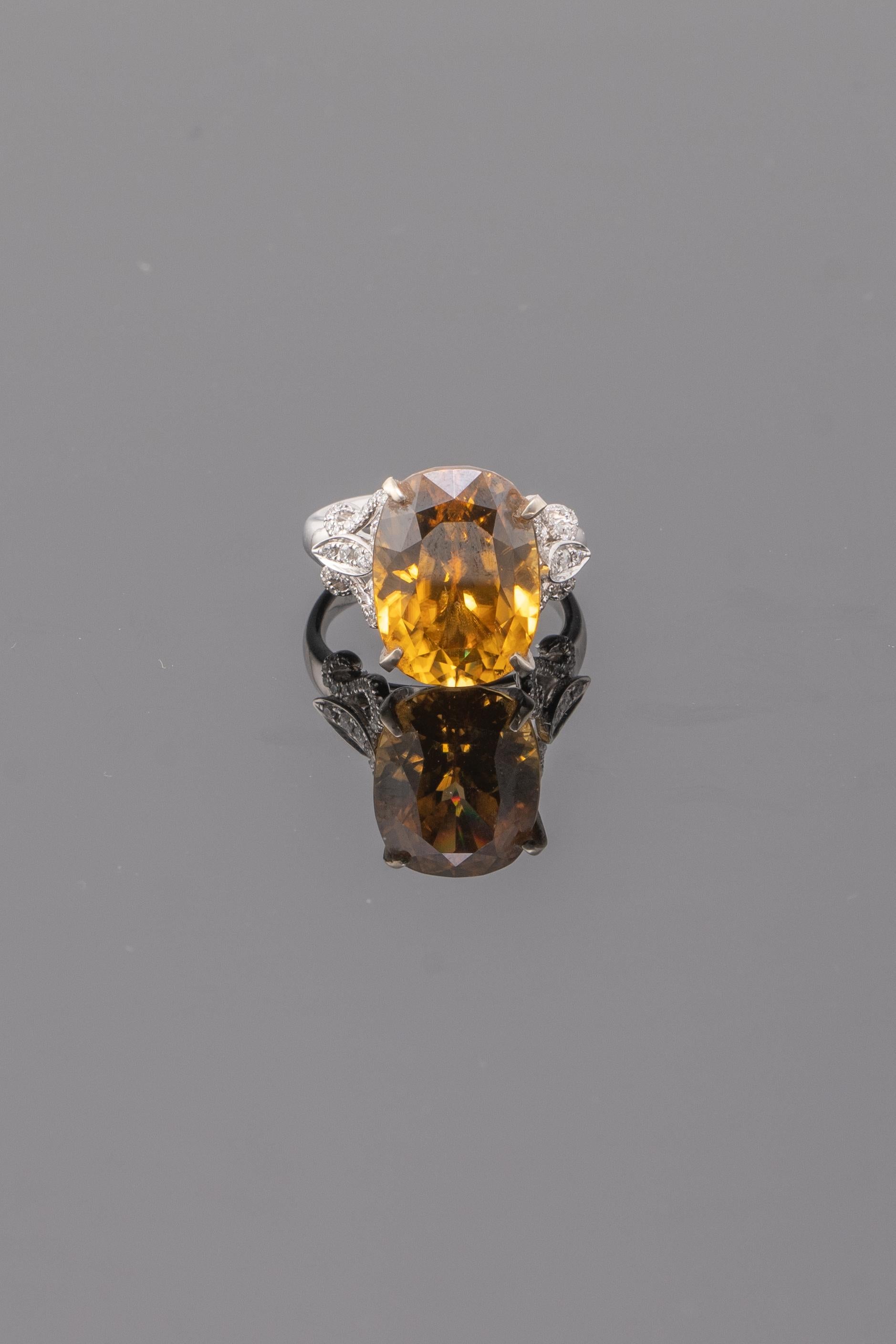 A cocktail ring with a very unique colored stone, 20.38 carat natural Yellow Zircon and Diamonds set in solid 18K White Gold - which can be worn casually and for formal events as well. The centre stone has great luster and fire, with a beautiful