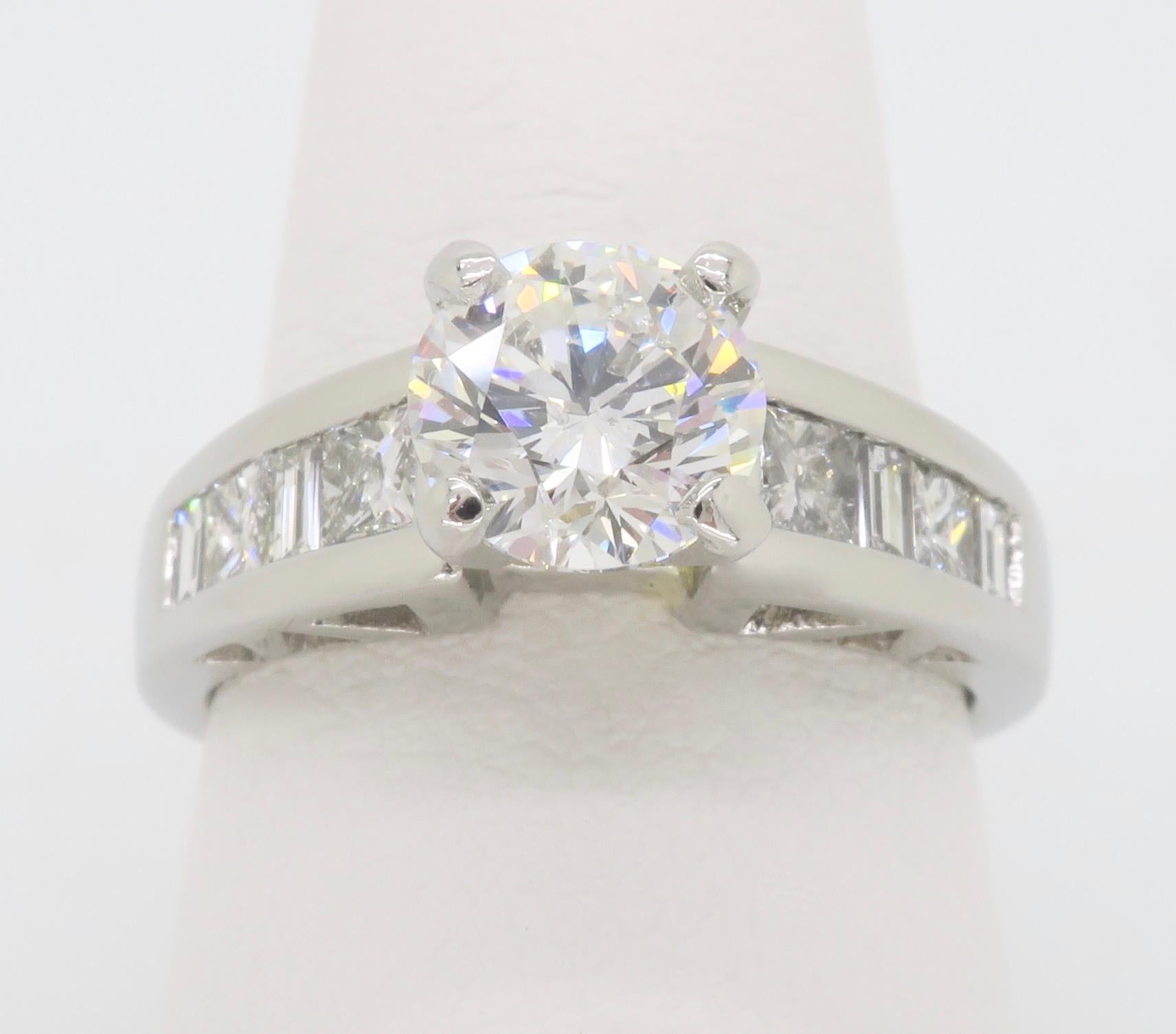 Certified 2.03CTW Diamond ring crafted in Platinum with Princess & Baguette cut accent diamonds. 

Center Diamond Carat Weight: 1.23CT
Center Diamond Cut: Round Brilliant Cut
Center Diamond Color: F
Center Diamond Clarity: SI2
Certification: IGI -