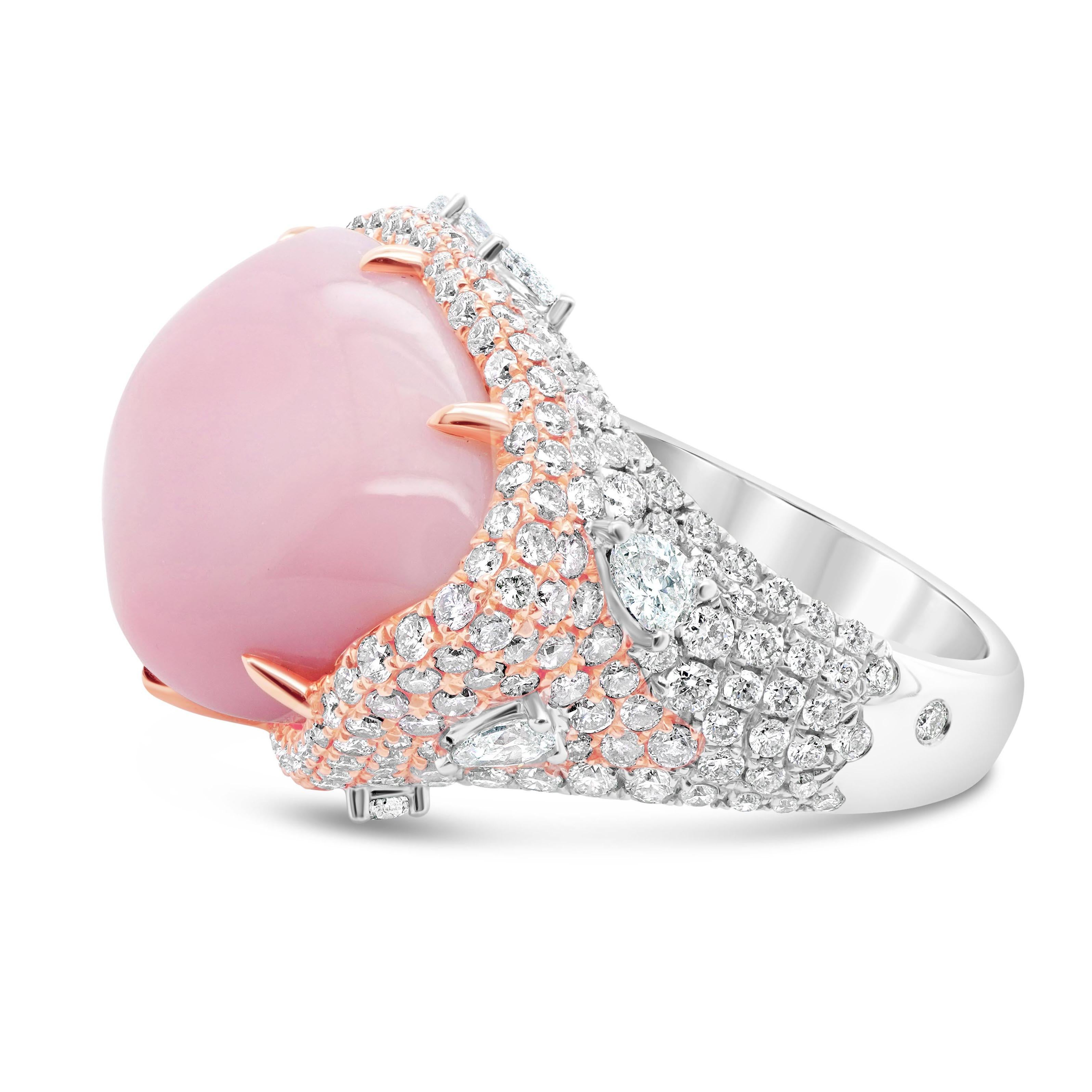 A rare 20.82 carat Caribbean conch pearl is set along with 1.19 carat of Fancy Pink Diamond and 1.31 carat of white brilliant round diamond. The ring is made in 18K and the total gram weight is 15.20 grams. Pretty and pastel-hued, a conch pearl is a