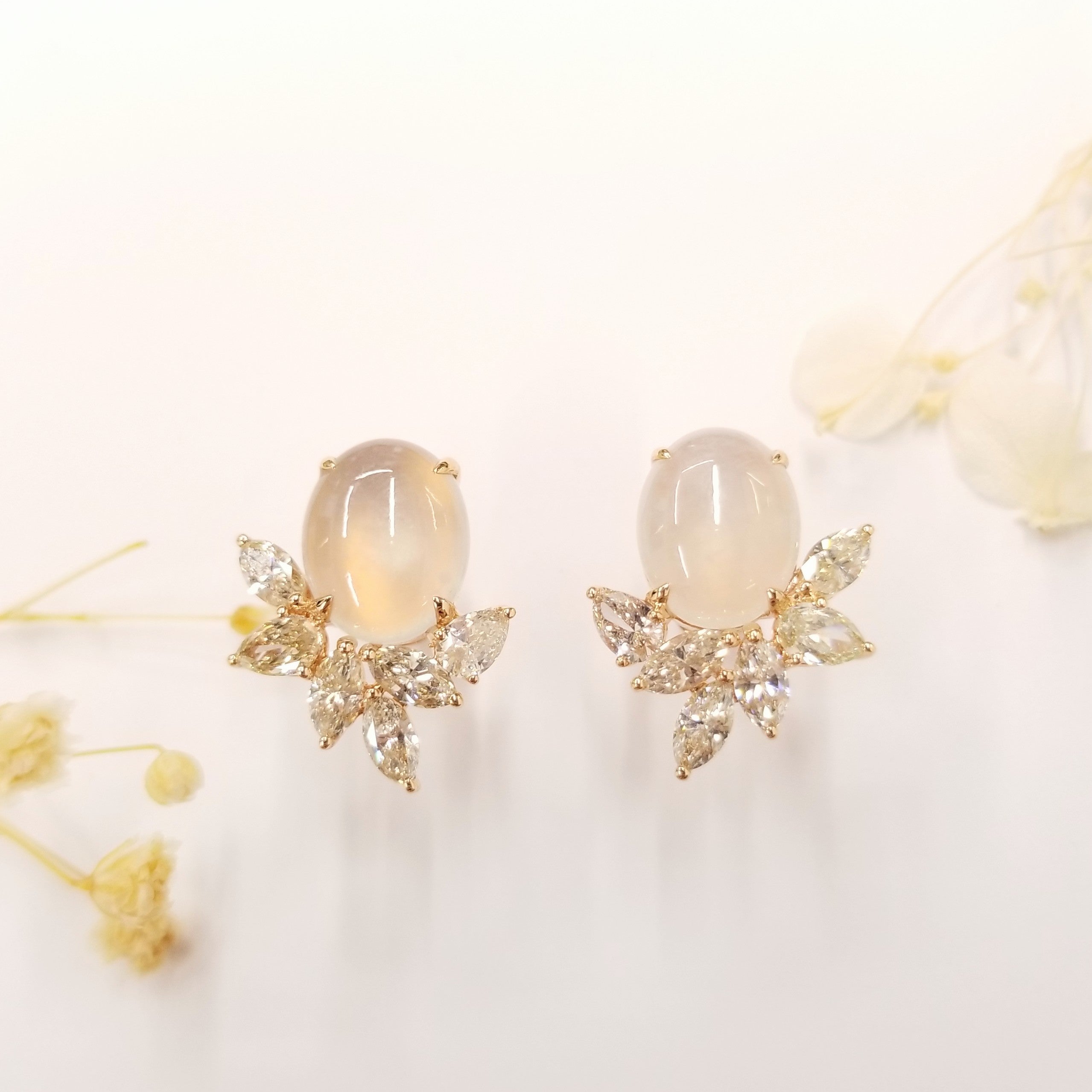 These captivating earrings showcase a symphony of elegance and allure, featuring a combination of certified diamonds and a mesmerizing white jade gemstone. Crafted in 18K rose gold, the earrings exude a warm and romantic glow, complementing the