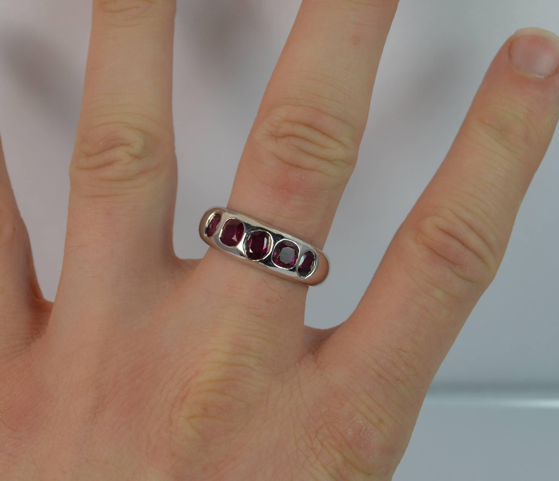 
A stunning 18ct White Gold and certified Burmese / Myanmar Ruby ring.

​Five stone design band ring. Each ruby has been assessed with no heat treatment. Total carat weight of 2.2 carats. The largest ruby to the centre measures 4.4mm x 4.0mm x