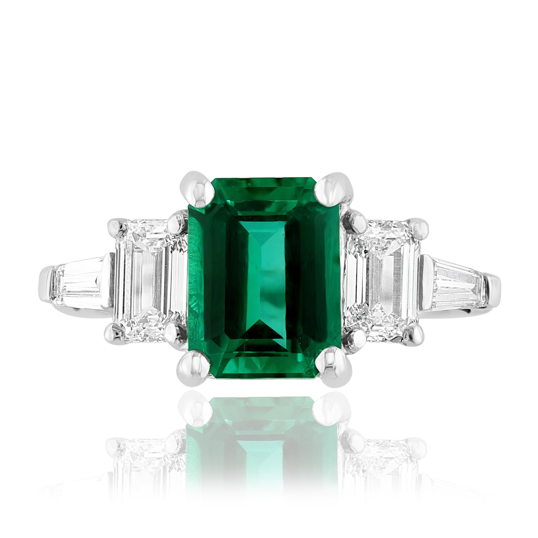 Showcasing color-rich 2.22 carat Certified emerald. Two perfectly matched GIA Certified baguette diamonds elegantly flank the center emerald cut emerald for a very classy and sophisticated piece. Additional 2 bullet cut diamonds channel set on a