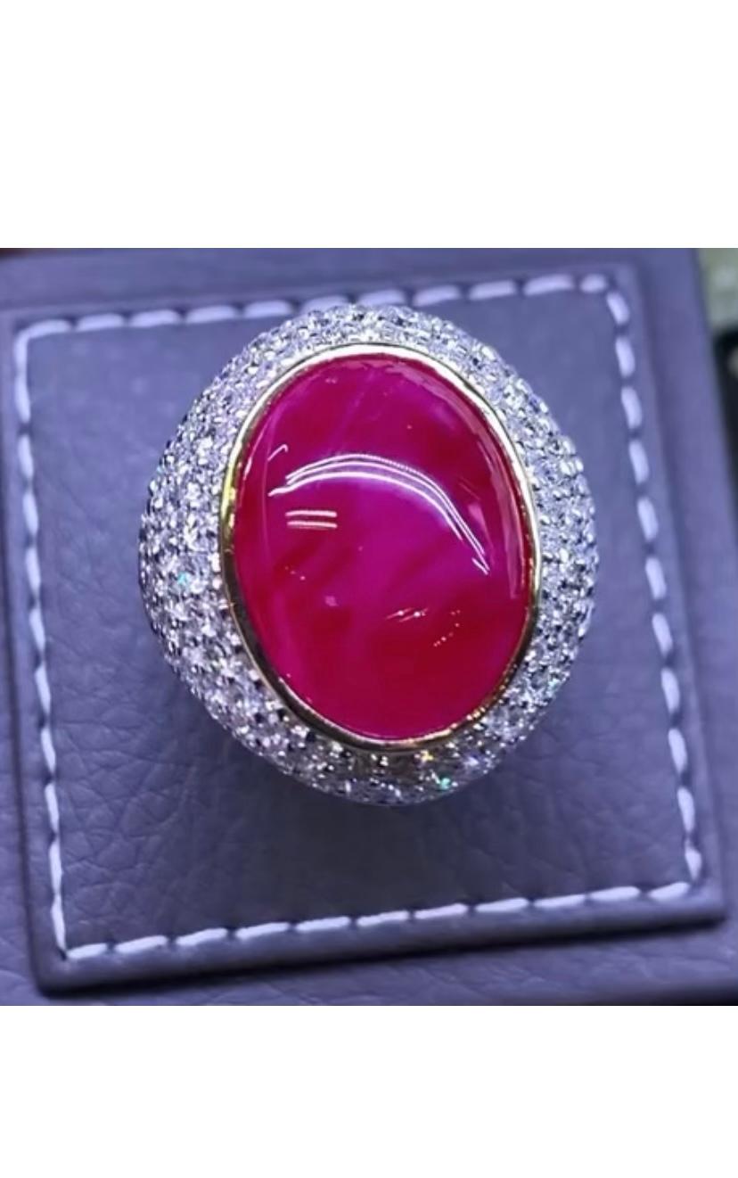 An magnificent ring in contemporary design, so essential and glamours very adorable style by Italian designer. 
Ring come in 18k gold with a natural Burma Ruby in oval cabochon cut  of 18,60 carats, fine quality, and round brilliant cut diamonds