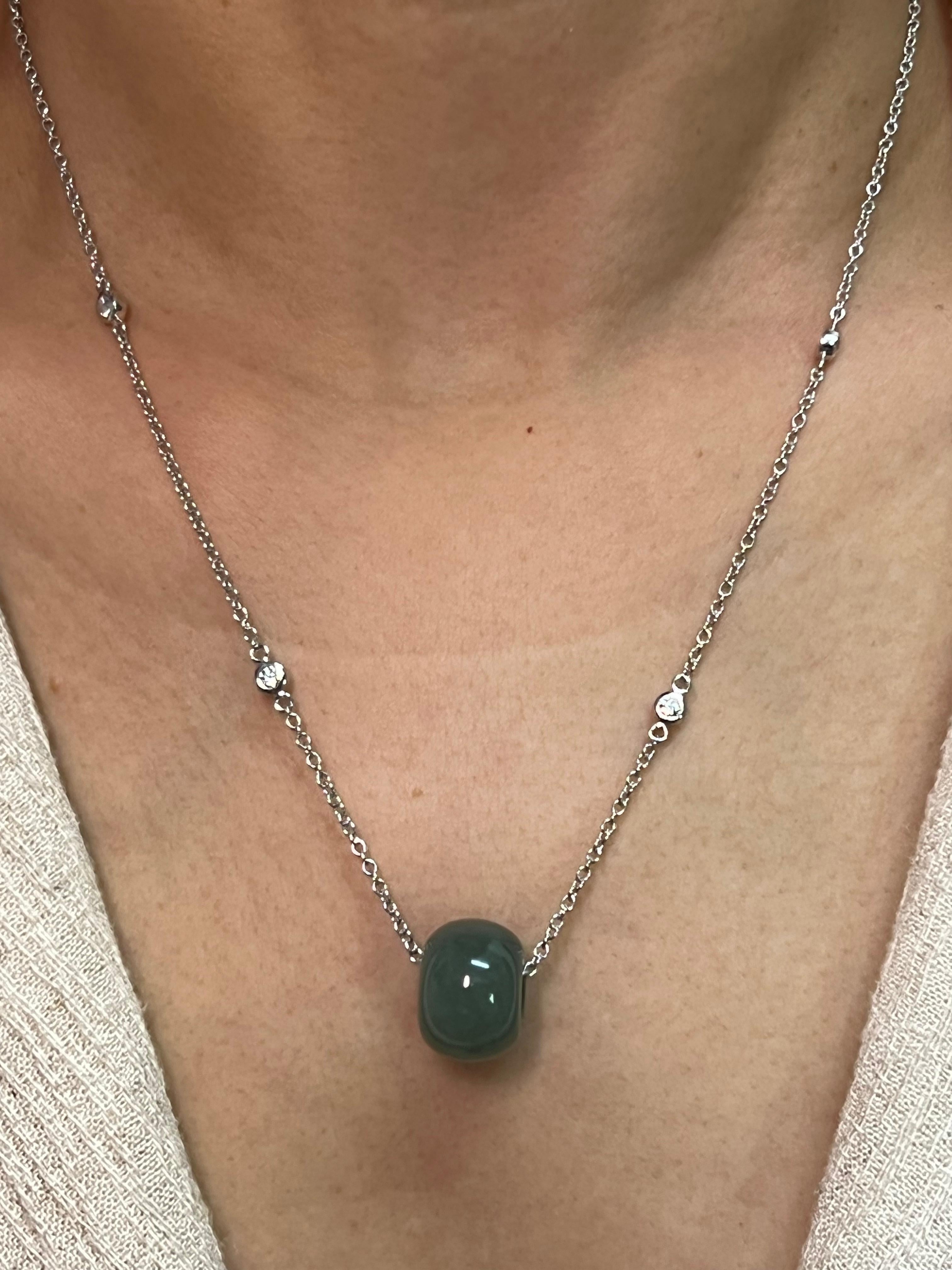 Please check out the HD video! Here is a nice Jade donut pendant with a custom diamond necklace. The jade's outer diameter is almost 15mm. The adjustable 16 and 18 inch necklace is set in 18k white gold and diamonds. There are 4 white diamonds