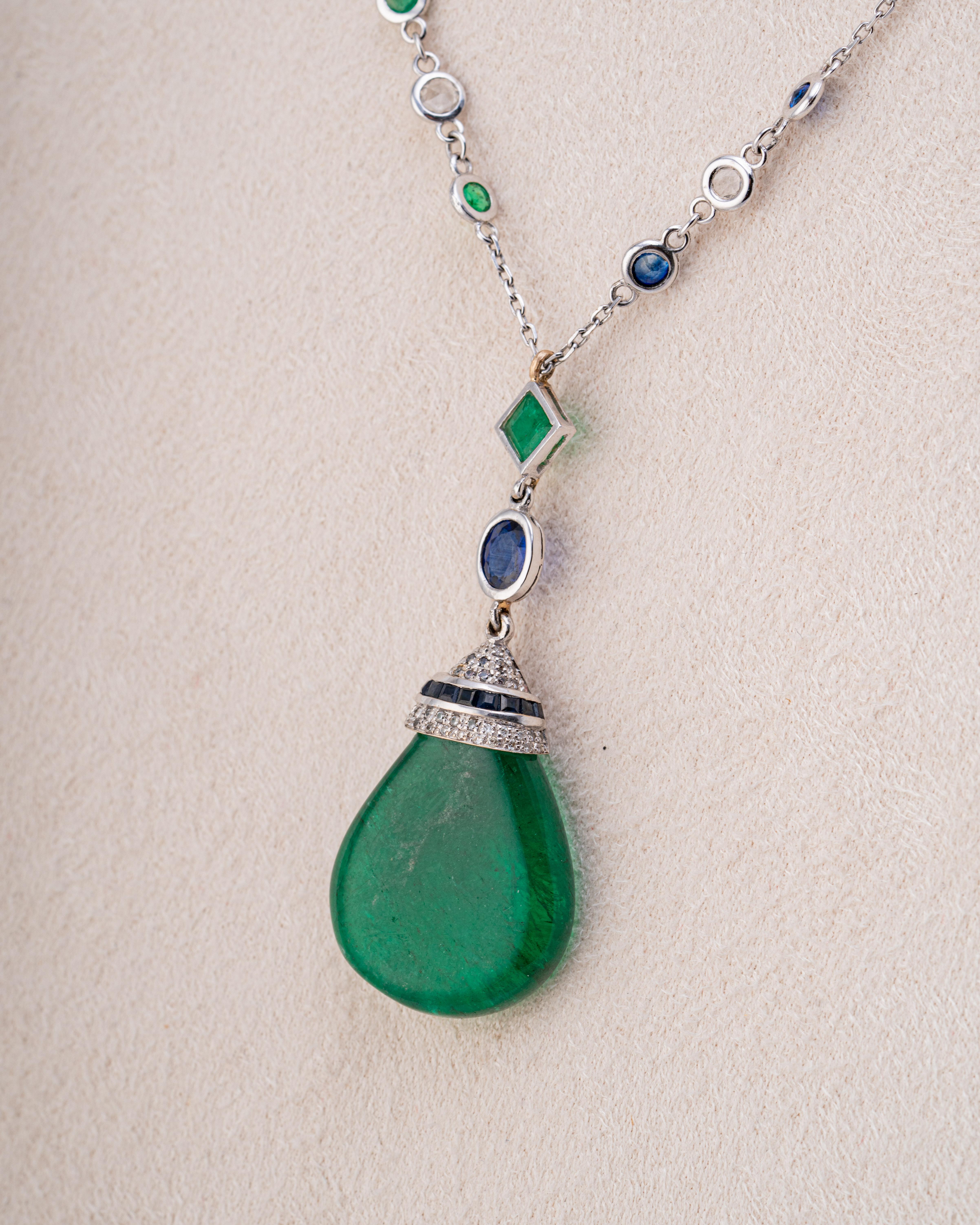 A very unique 23.95 carat drop-shaped Emerald pendant, with Emeralds, Sapphires and White Diamonds - set in 10 grams of solid 18K White Gold. The chain is currently 24 inches long, but it can be customized. The green and blue color combination makes