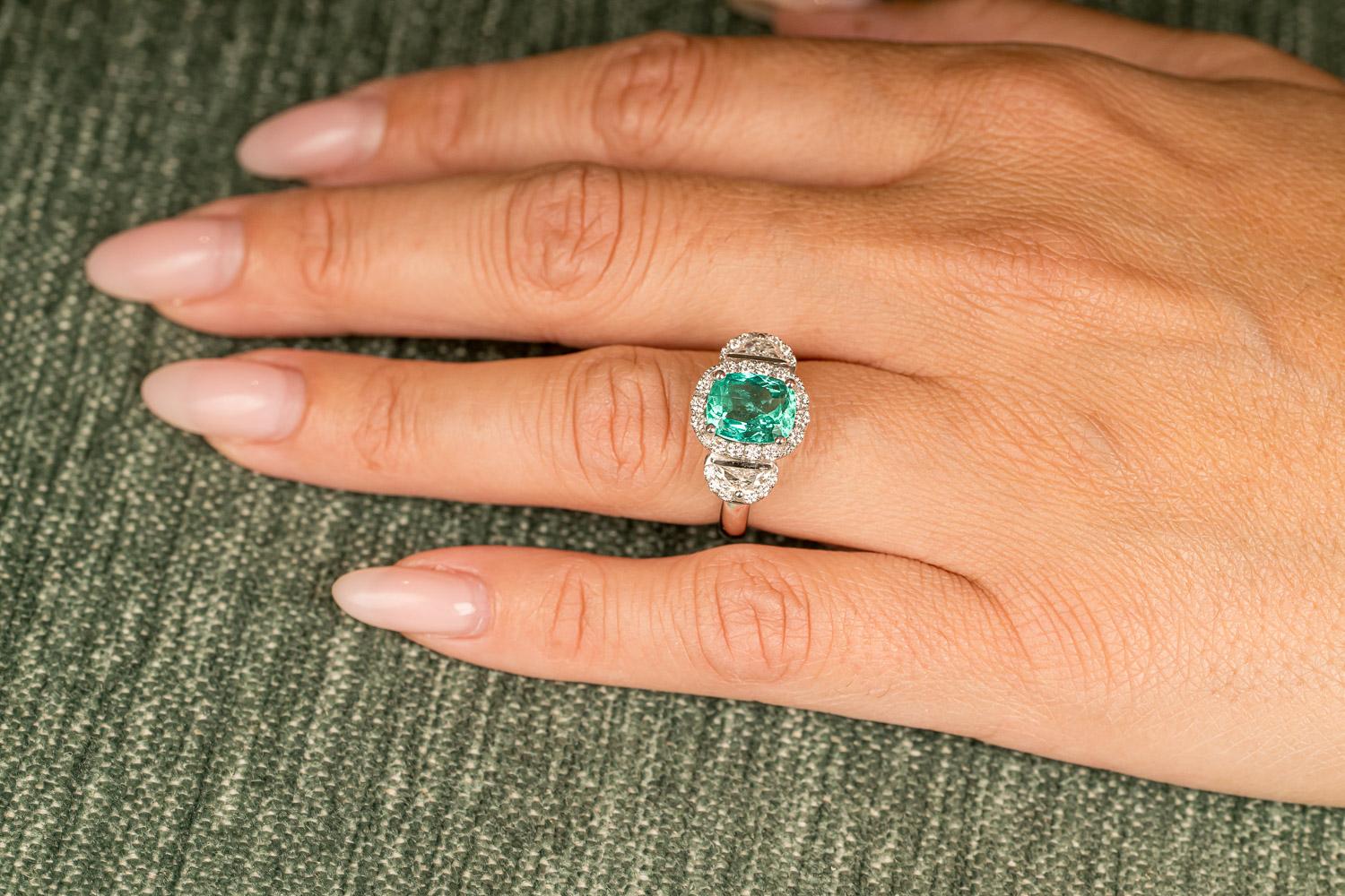 One of a kind three-stone engagement ring in 18-Karat white gold 9,2g set with 1 certified natural green Colombian emerald in cushion cut 2.47 Carat and the finest diamonds in VVS/DE quality in moon cut 0.45 Carat and 0.79-Carat brilliant cut