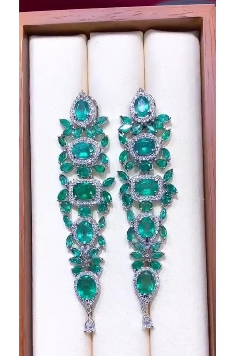 An exclusive pair of Emeralds and Diamonds earrings .
This exquisite  designer earrings is the epitome of luxury. Featuring dazzling Diamonds , and multitude of scintillating vibrant Zambian Emeralds, it exudes opulence and refinement .
A true
