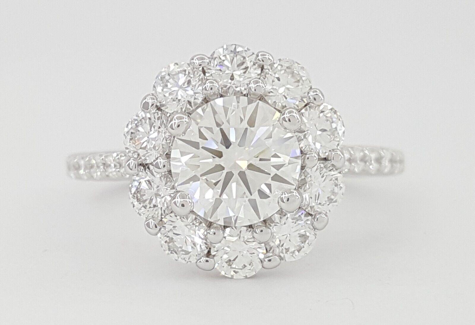 This sophisticated  Round Brilliant Cut Halo Diamond 18k White Gold Engagement Ring GIA. 

