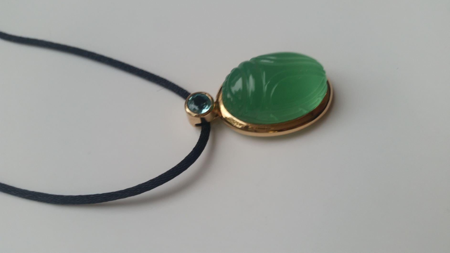 In old Egypt the scarab was a symbol for resurrection and life and since that time a lucky charm for everyone. This beautiful 18k rose gold scarab pendant with a Calcite 28.53 ct and a Apatite 0.60 ct could be your personal lucky charm.
