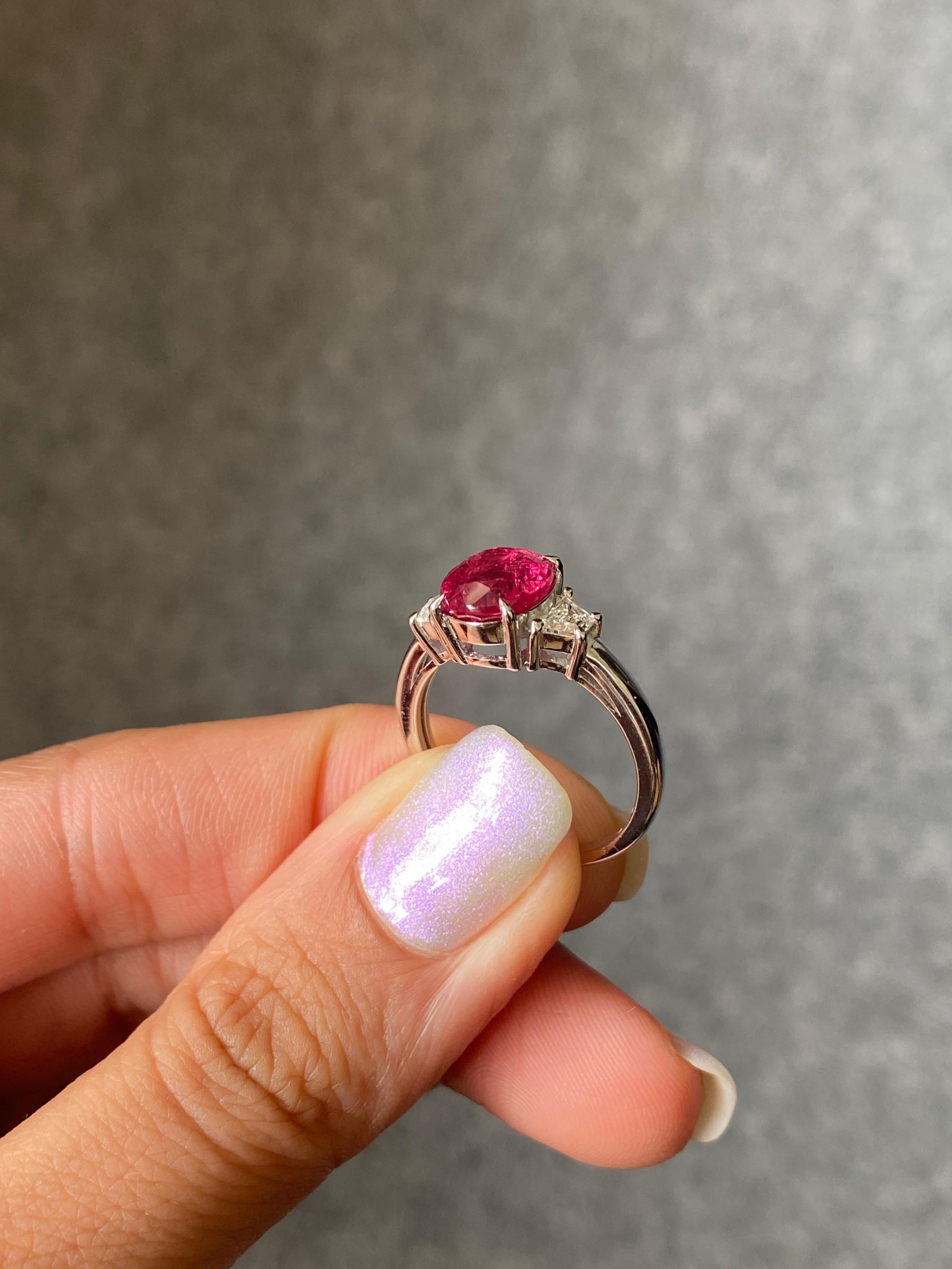 A beautiful 3.01 carat natural, no heat/treated Thai Ruby with 0.32 carat VS quality trapeze shaped White Diamonds, all set in 18K solid White Gold. The Ruby is transparent, with a stunning pinkish-red color and great luster. The ring is currently