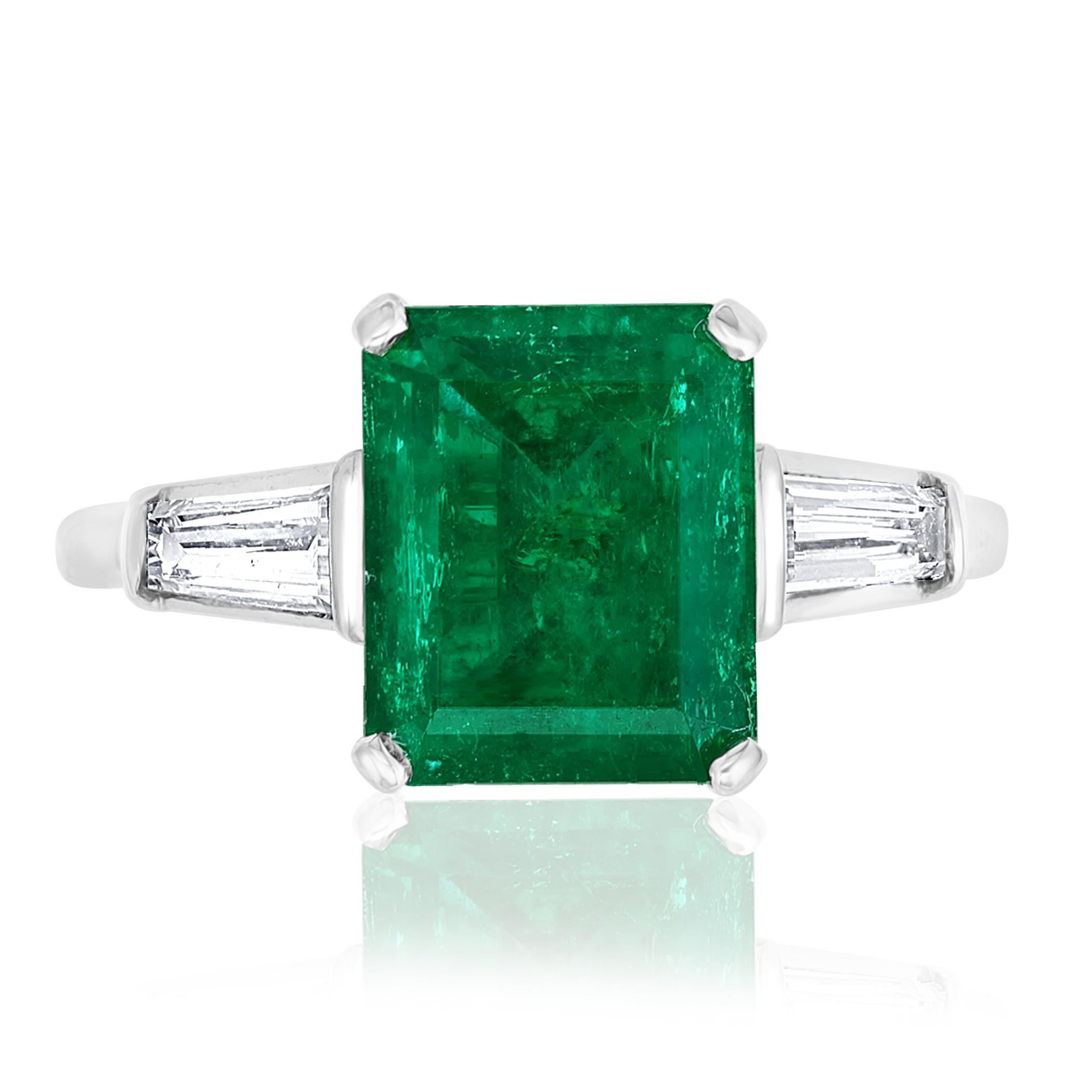 Wonderful  Emerald cut columbian Emerald weighing 3.04 carats. The emerald has a deep green color and is eye clean. The ring has 2 baguette diamond side stones weighing 0.18 carats total. Made in 14K white gold. Size 6.5 (sizable).

One of a Kind 