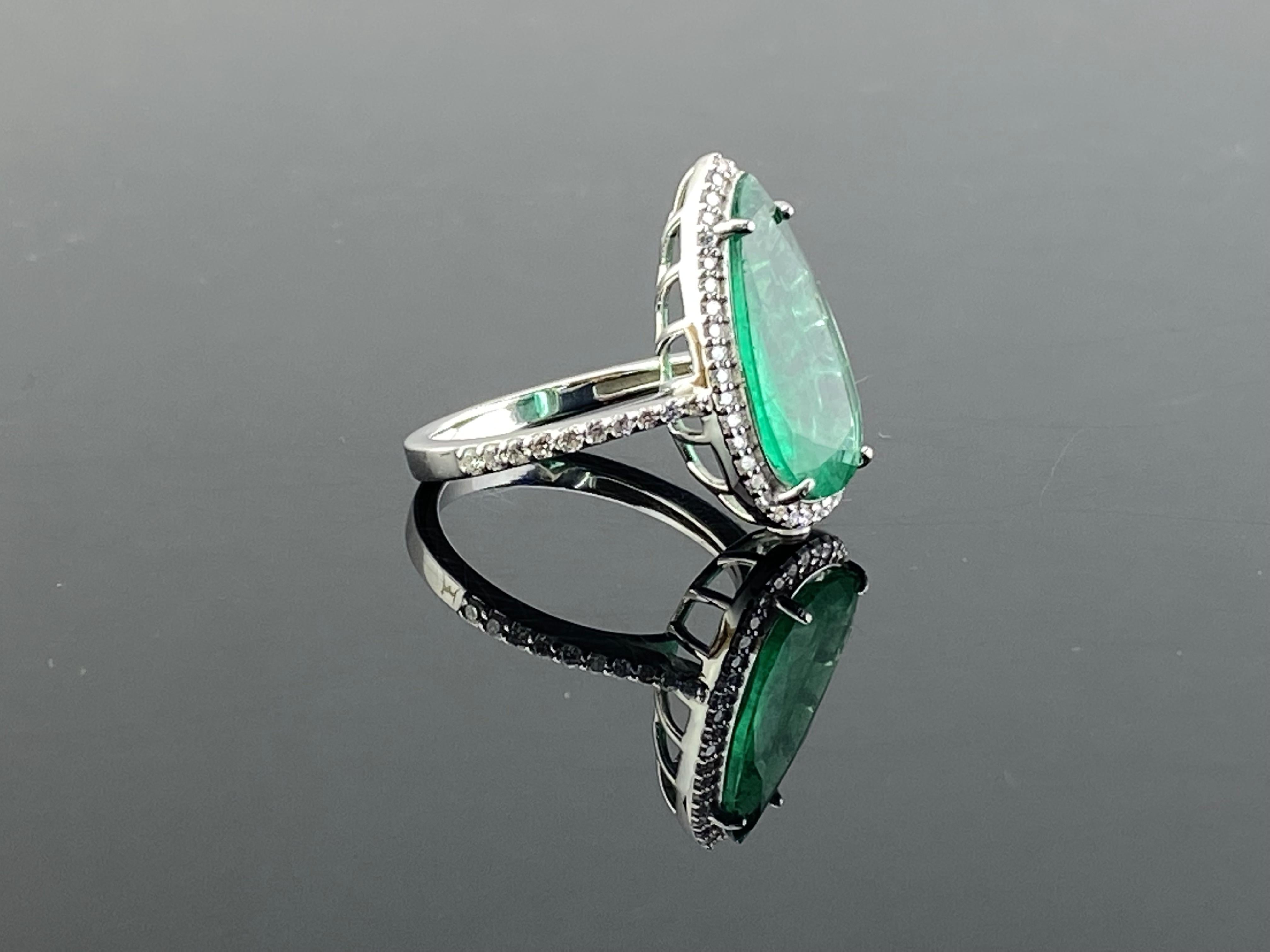 A beautiful 3.20 carat, pear shape Zambian Emerald and Diamond cocktail engagement ring. The Emerald is transparent, with a beautiful vivid green color. The Emerald looks larger than a 3.2 carat due to the excellent cut. Around 0.4 carats of White