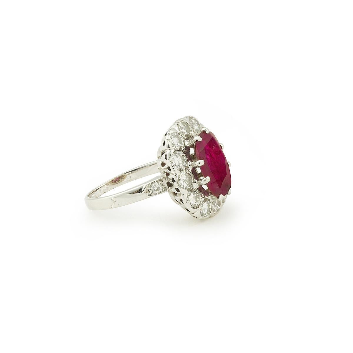 A fine vintage 18 K white gold so called “Pompadour” ring with a central cushion cut ruby, surrounded by 12 round cut diamonds 

Ruby's Weight approx: 3.20 carats
With certificate from Gem Paris specifying of his origin, his weight and