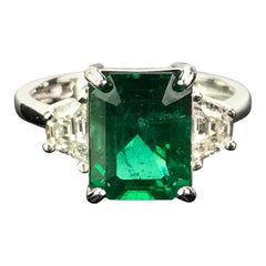 Certified 3.22 Carat Emerald and Diamond Three-Stone Engagement Ring