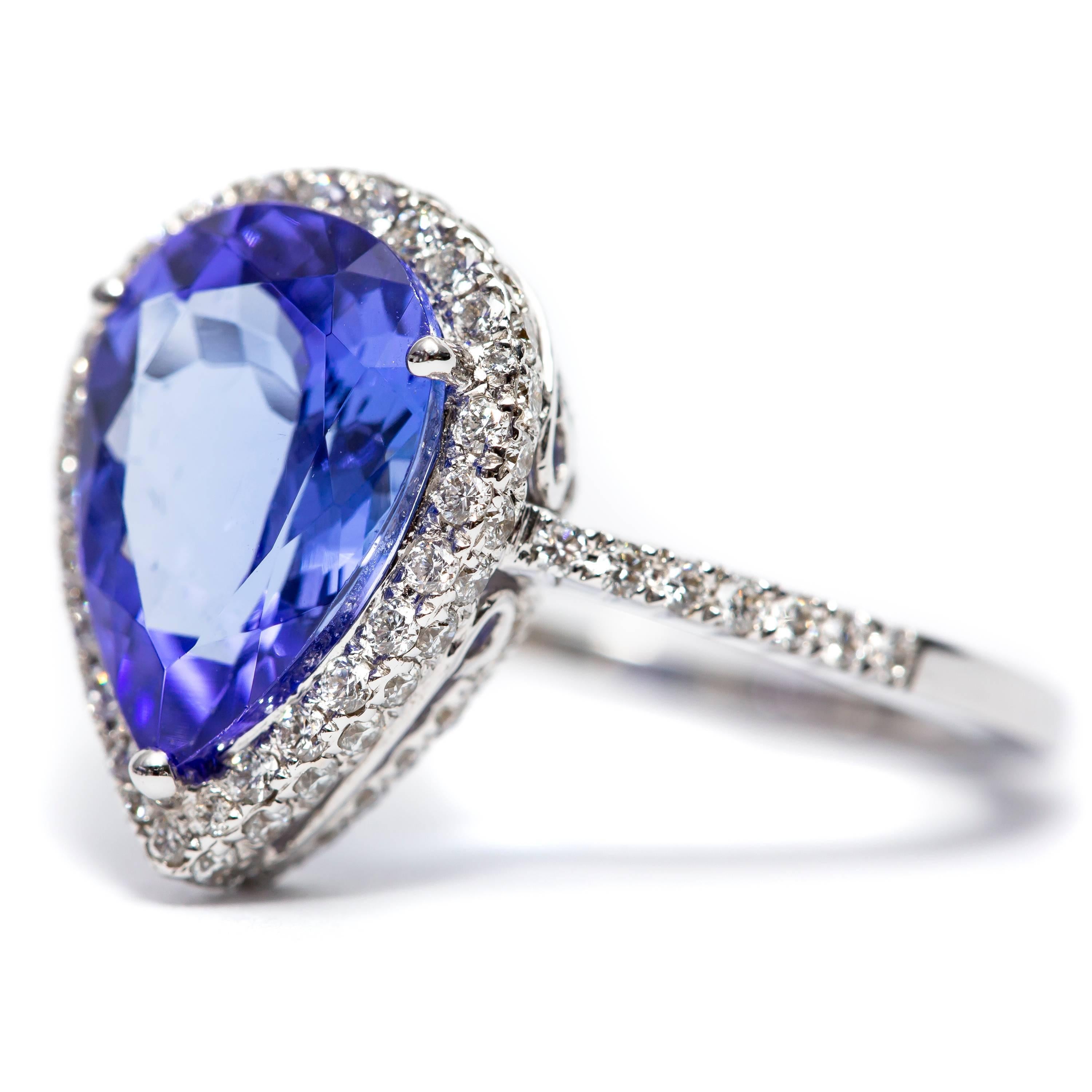A beautiful 3.26 Carat Pear shaped Tanzanite halo engagement ring featuring 0.75 Carats of white Color G Clarity VS1 Round Brilliant Cut Diamonds. Set in 18 Karat White Gold. 
UK size - N, US size - 7 available in other carat sizes as well as ring