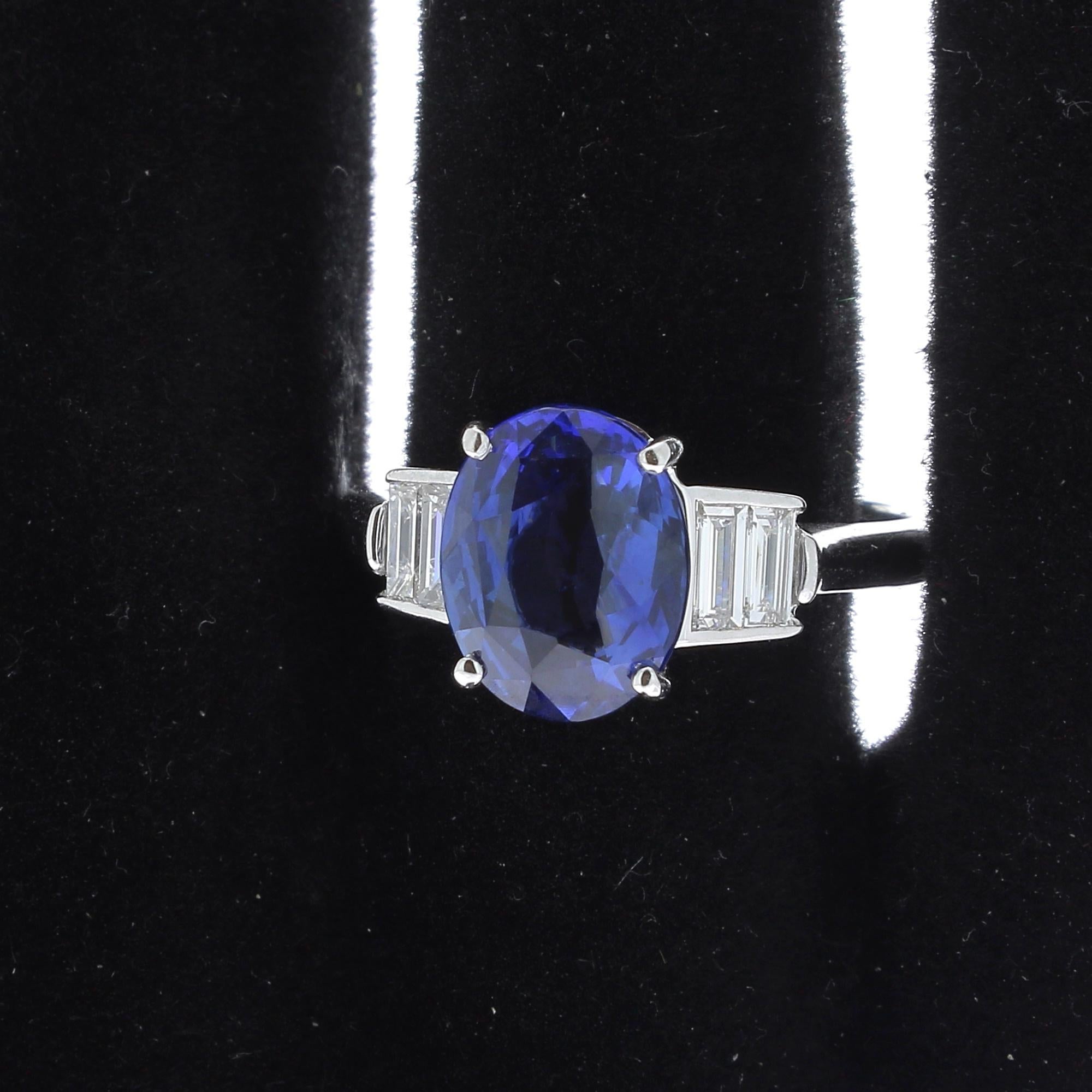 A Ceylon Sapphire Ring, flanked on each side by 2 Baguette Diamonds.
The total weight of the Ceylon Sapphire ( Sri Lanka Sapphire ) is 3.52 Carat.
The Baguette Diamonds weight is 0.30 Carat ( 4 Baguette-cut Diamonds).
The Sapphire is certified as a