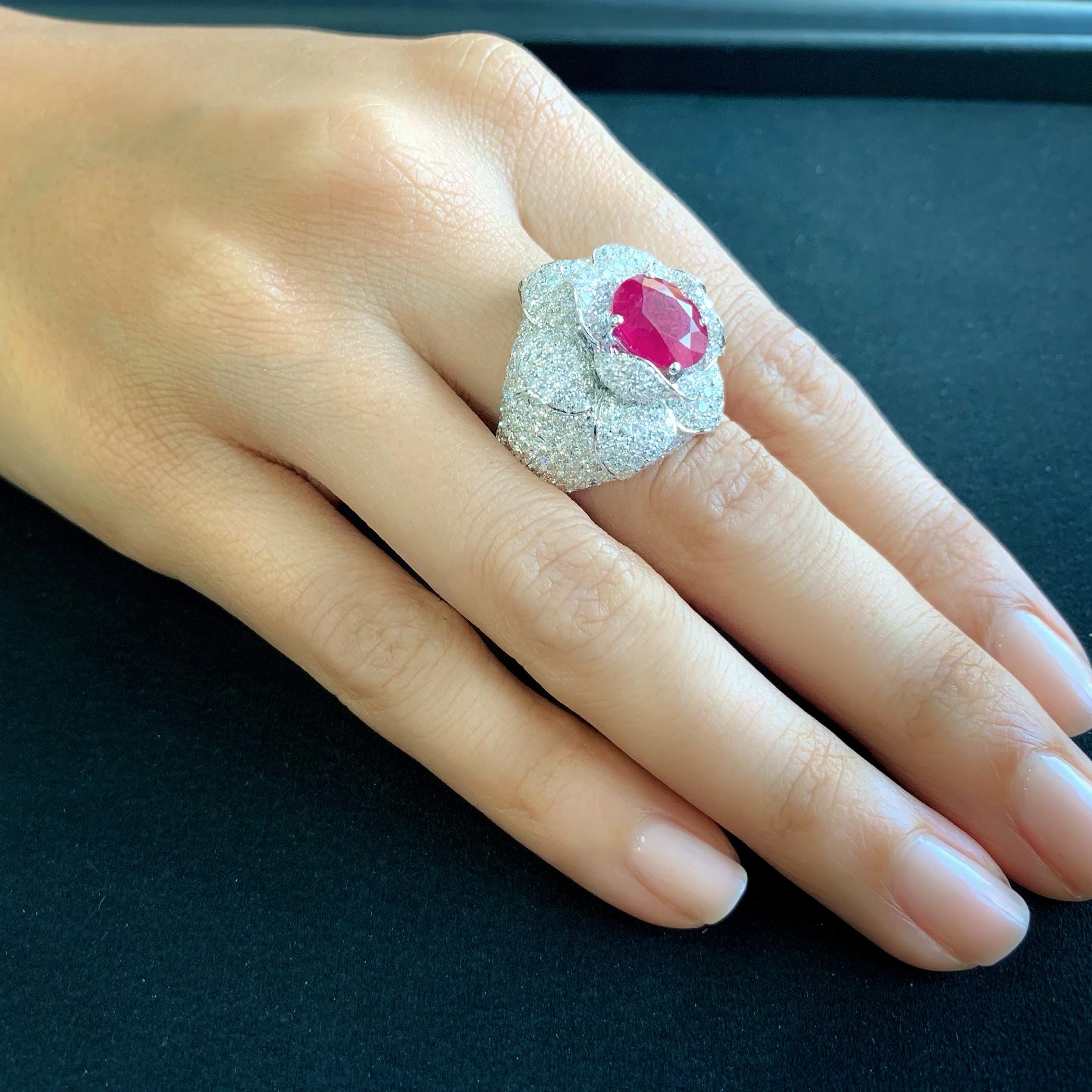 Butani's glamorous ruby and diamond ring features a certified 3.71 carat vivid oval ruby center stone, surrounded by 5.1 carats of pave white diamonds in a floral setting.  Handcrafted in 18-karat white gold.  Currently a ring size US 7.  For other