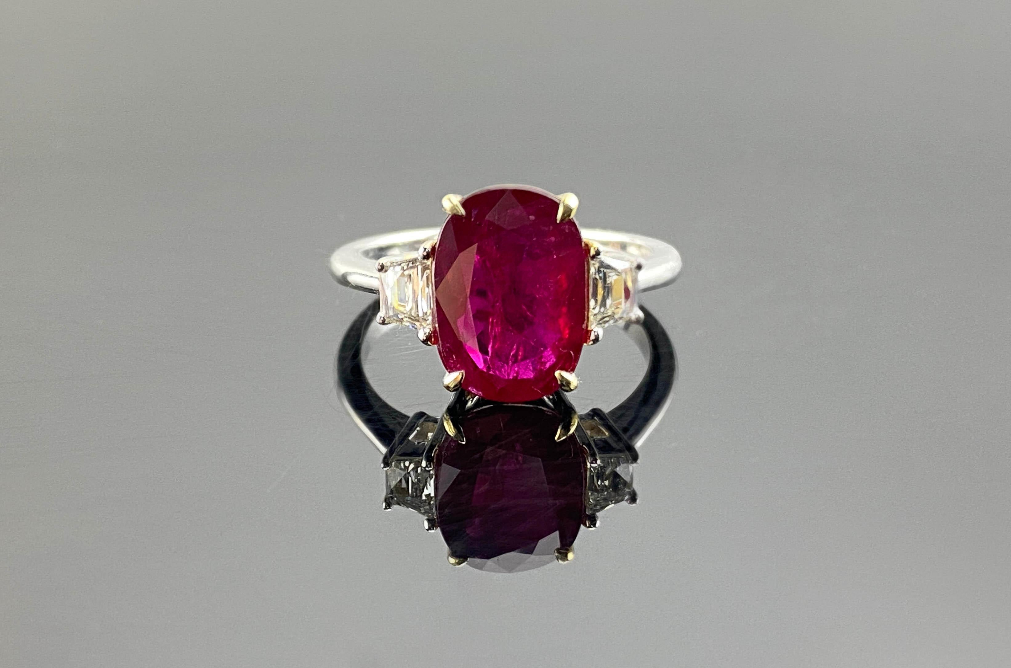 A classic 3.74 carat Burmese Ruby, with trapeze shaped White Diamonds, all set in solid 18K White Gold. The center stone oval shaped Ruby is transparent, with a beautiful vivid red color and great luster.
The ring is currently sized at US 7, can be