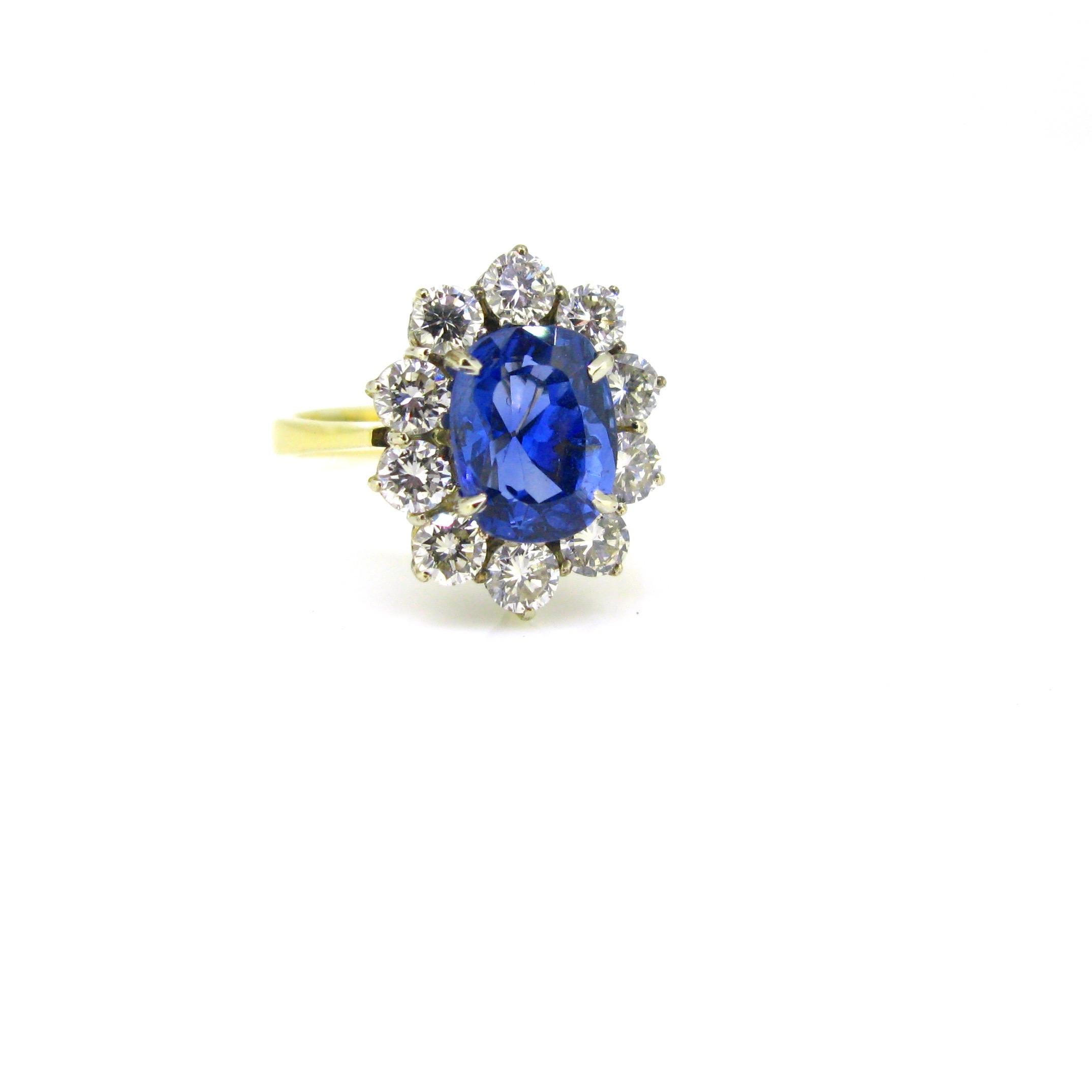 This beautiful ring is set with a 3.84ct No heat sapphire. It comes with a certificate from Gem Paris. The sapphire is surrounded by 10 brilliant cut diamonds for a total carat weight of 1.50ct approximately. It is an absolute stunning ring.