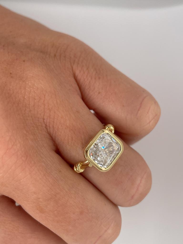 Radiant Cut 1ct CushionCut Diamond Engagement Ring bezel set in 18ct yellow gold