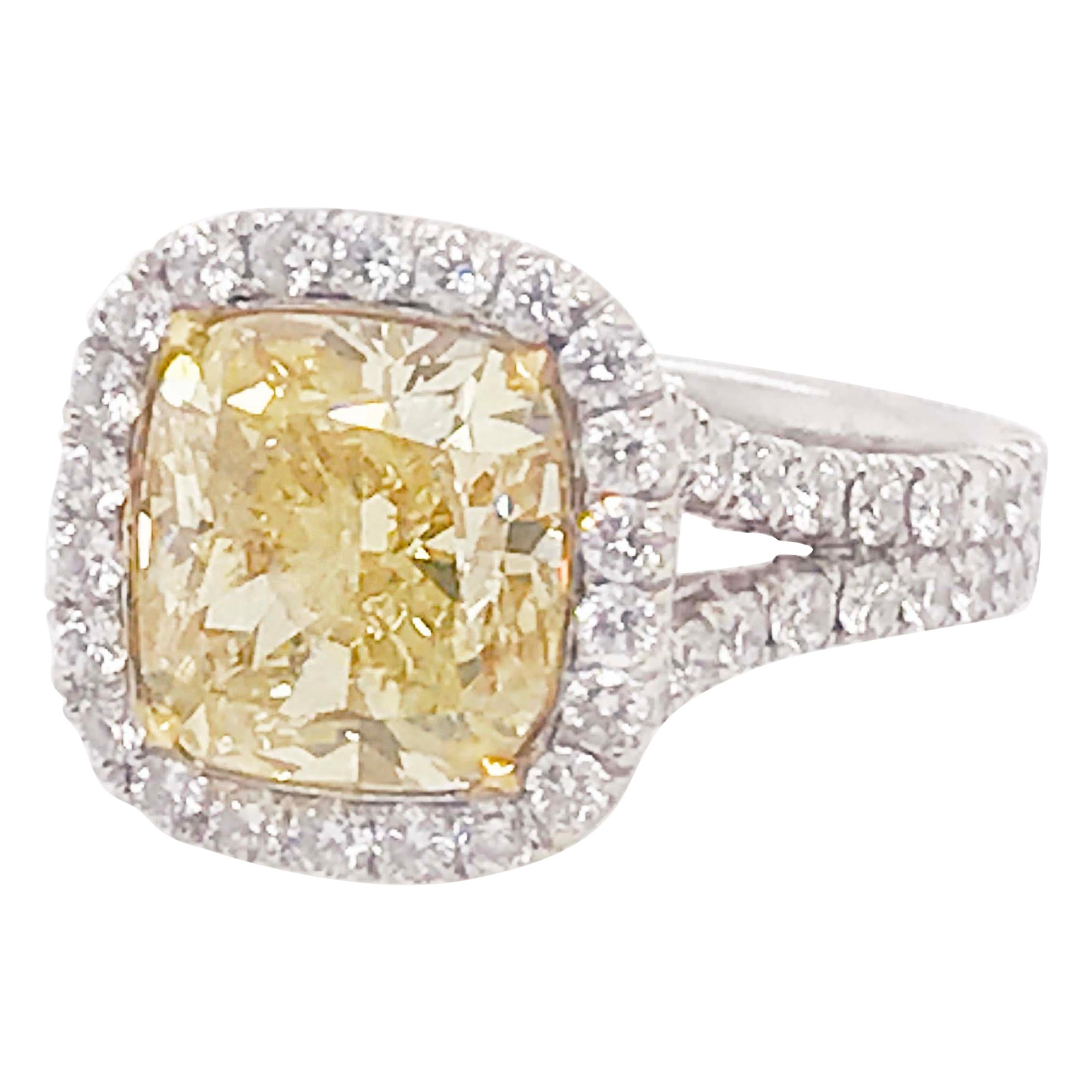 Certified 4 Carat Fancy Yellow Diamond and White Diamond Halo 18 Karat Ring