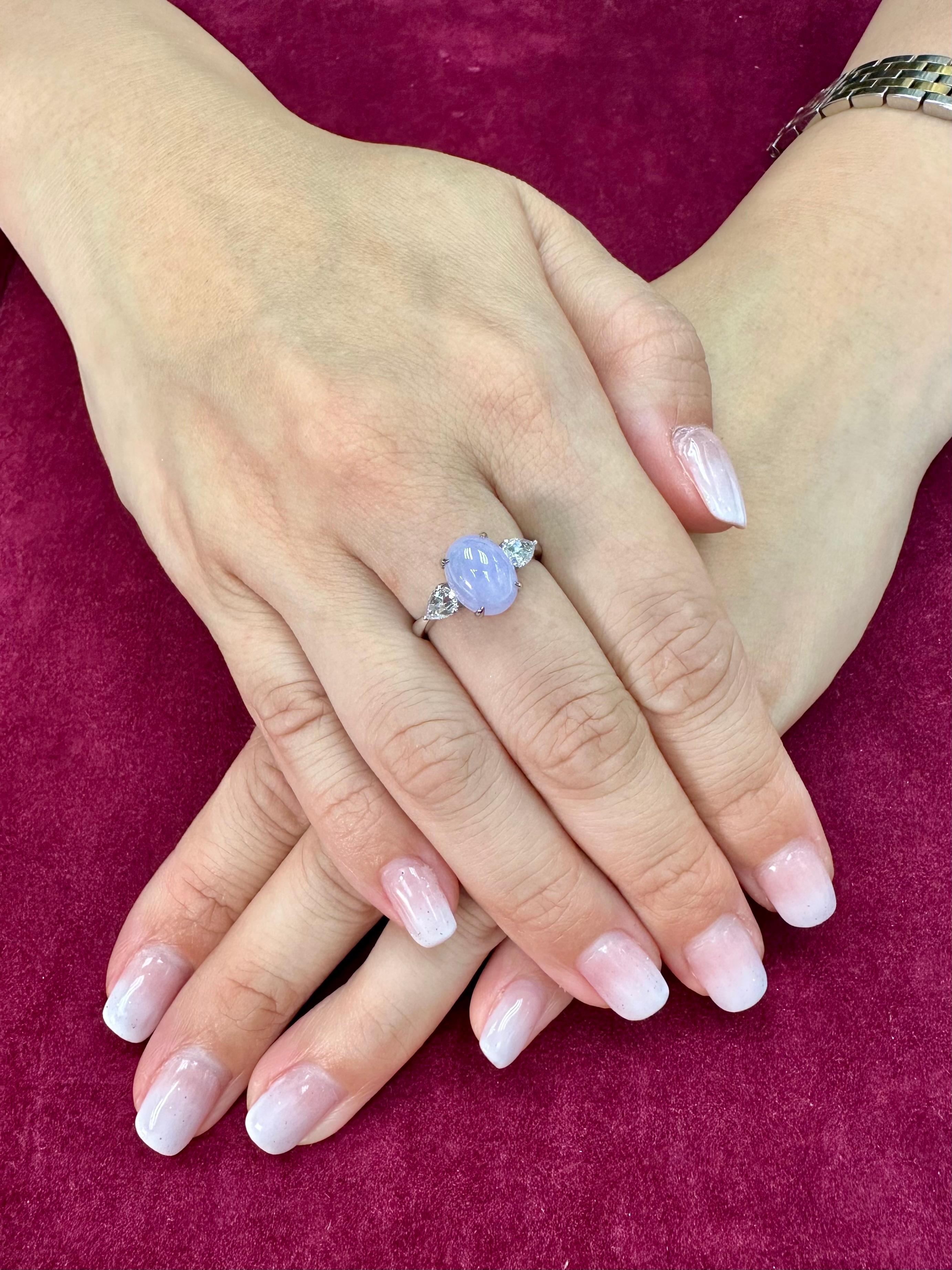 Please check out the HD Video! Here is a very eye pleasing lavender jade and diamond 3 stone ring! It is certified natural jadeite jade. The ring is set in 18k white gold and diamonds. There are 2 new rose cut pear shaped diamonds that are on each