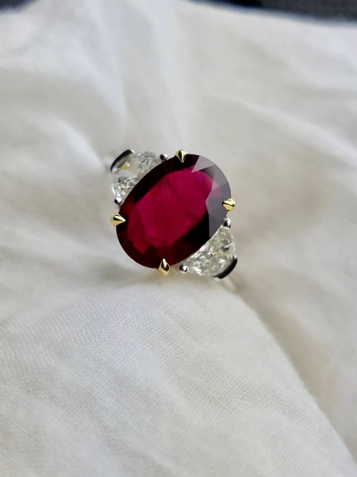 Beautiful, certified, no heat Mozambique Ruby (eye-clean) ring with 2 half moon Diamond side stone, set in 18K Gold.

Stone Details: 
Stone: Mozambique Ruby
Cut: Oval
Carat Weight: 4.02

Diamond Details:
Cut: Half Moon
Total Carat Weight: