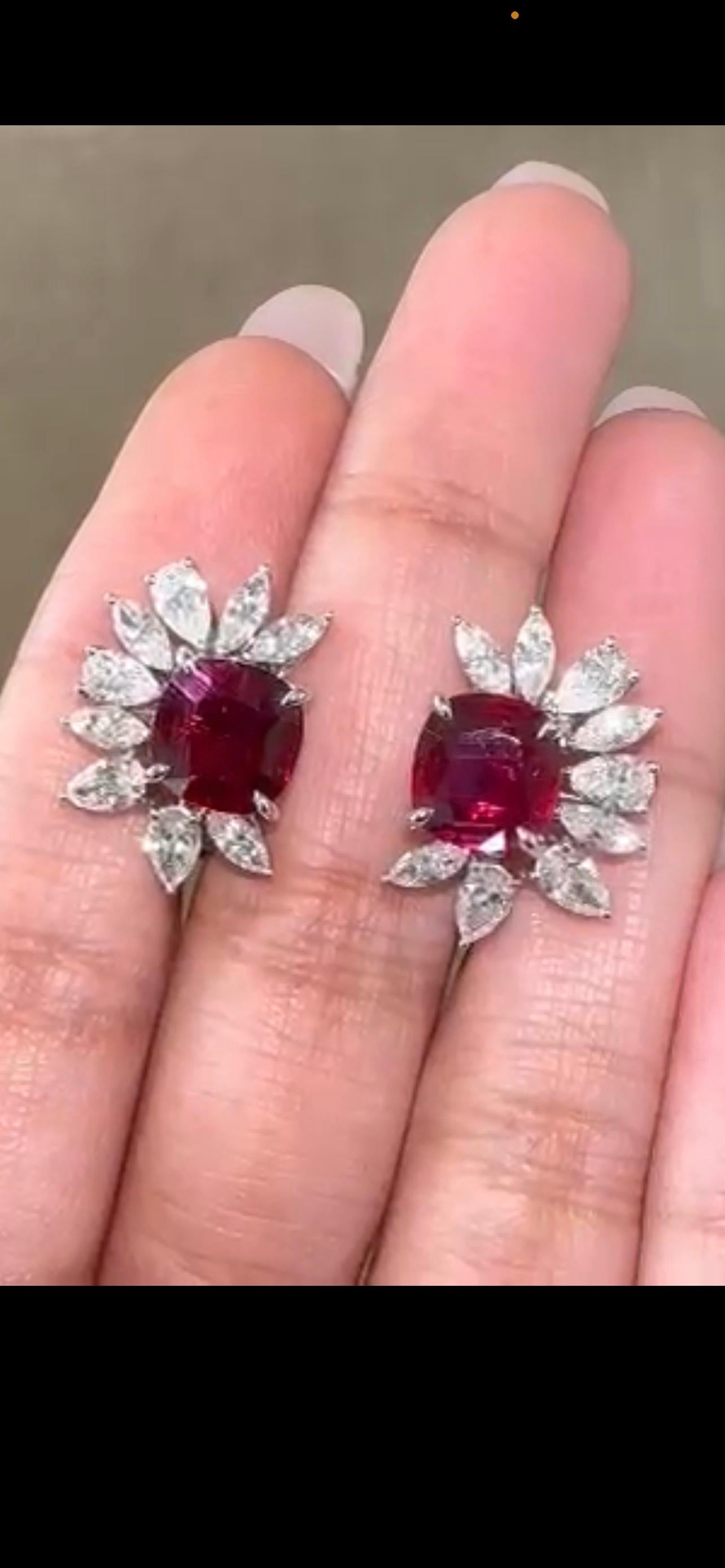 A pair of certified cushion shaped 4.06 carat no heat Mozambique Ruby studs, with 2.20 carat VS quality marquise and pear shaped Diamonds set in solid 18K White Gold. 
