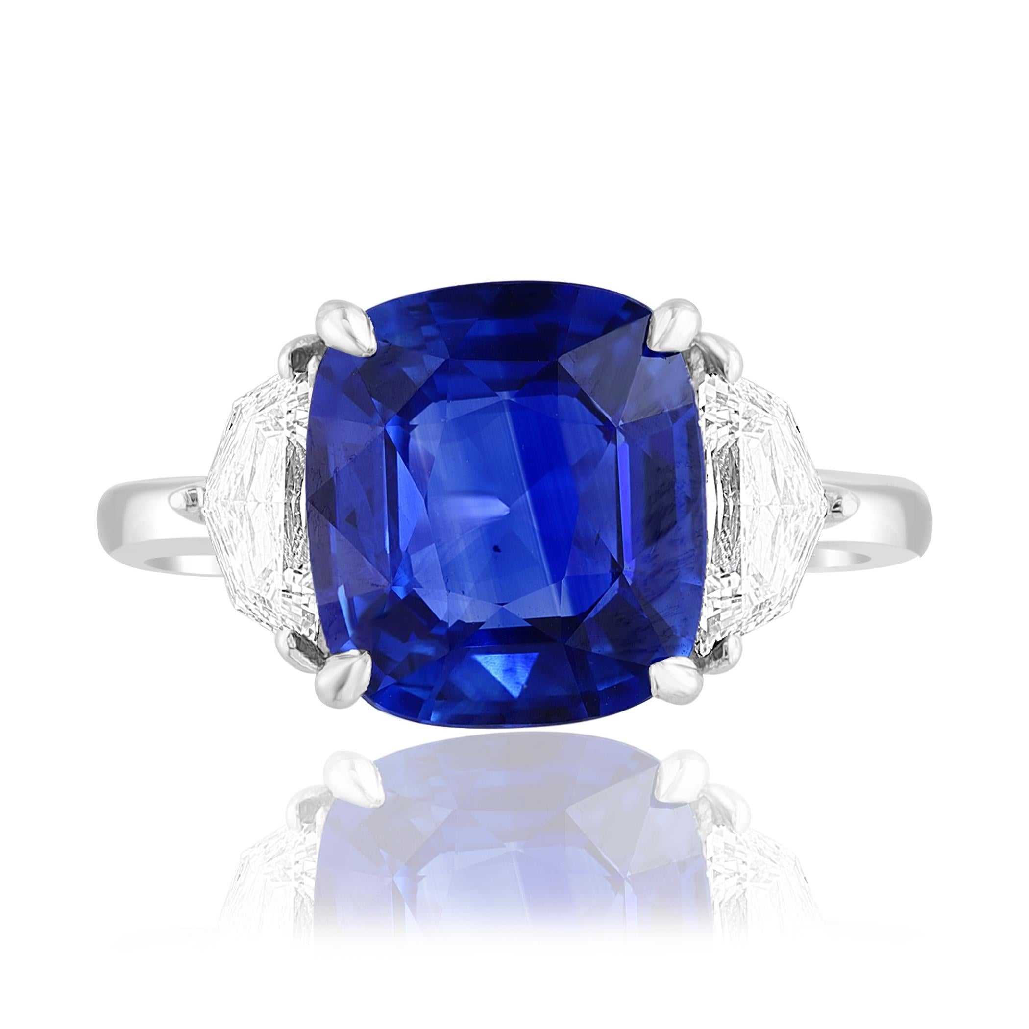 Showcasing Certified Cushion cut, Vibrant color Blue Sapphire weighing 4.15 carats, flanked by two brilliant cut half moon diamonds weighing 0.70 carats total. Elegantly set in a polished platinum composition.