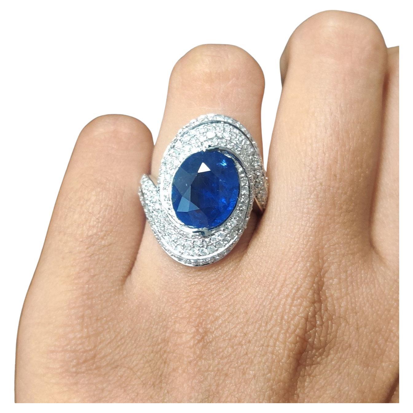 This 4.32 carat Blue Sapphire Fancy Cocktail Ring in 18K White Gold features a centerpiece originating from Sri Lanka. The Sapphire, with a royal blue hue, is oval-cut and has undergone normal heat treatment only, ensuring its natural beauty. The