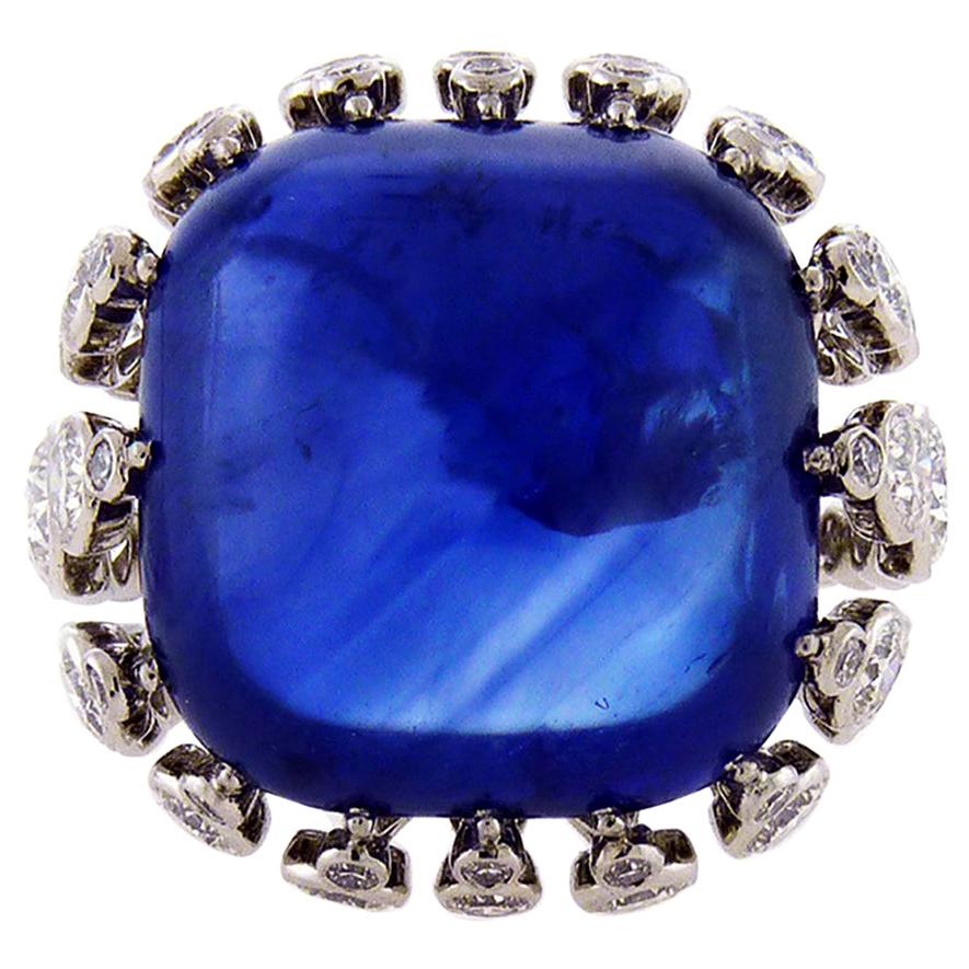 A fabulous cocktail ring embellished with a cushion sugar-loaf cut sapphire weighing 43.22 carats.
The sapphire is accompanied by two certificates from AGL and GRS laboratories stating that the sapphire is of Ceylon origin with the indication of