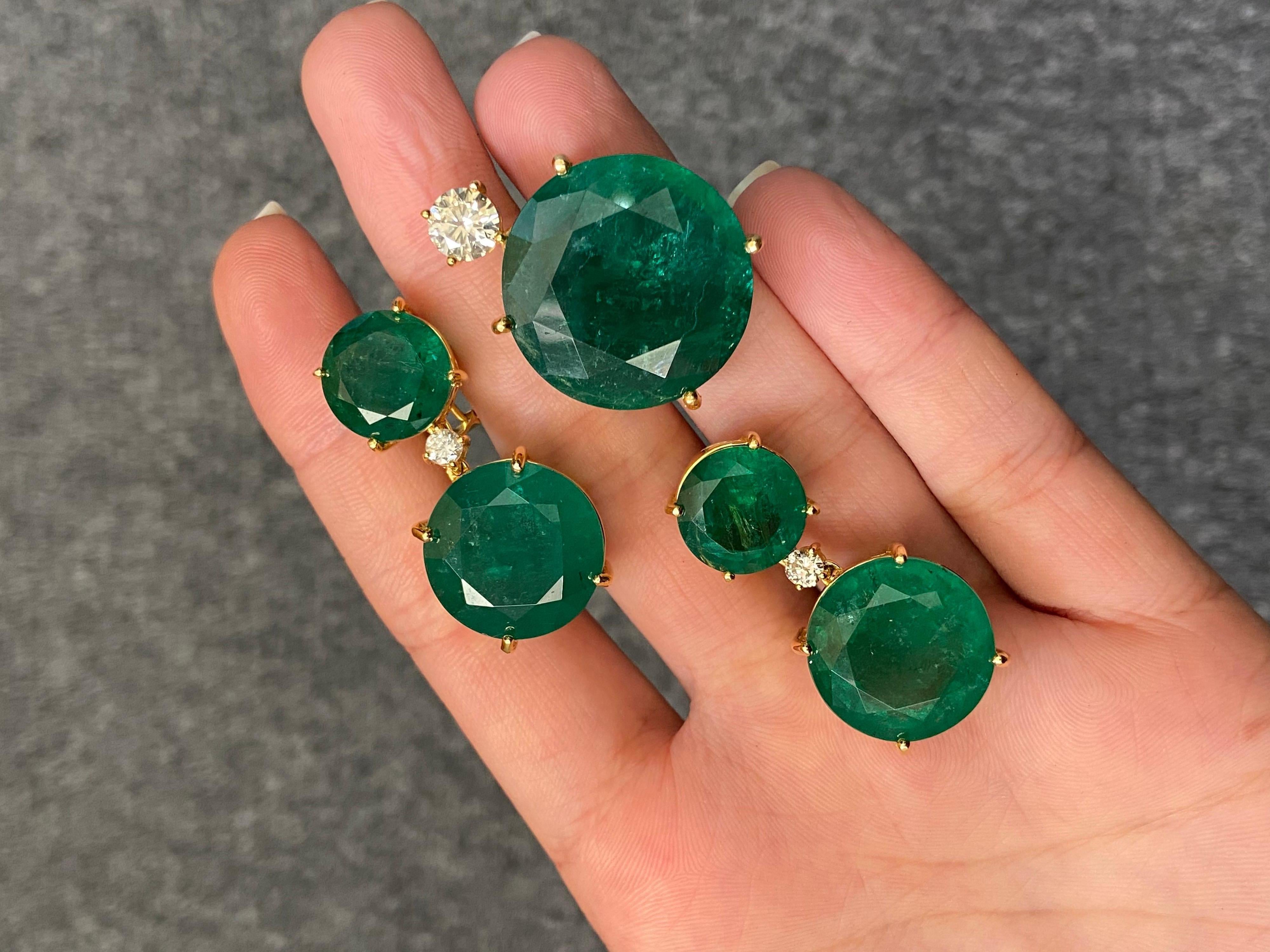 A beautiful pair of natural round cut Zambian Emerald and Diamond earrings all set in solid 18K yellow gold. It is unusual to find Emeralds of this quality, shape and size. These stones are transparent, with some naturally occuring inclusions,