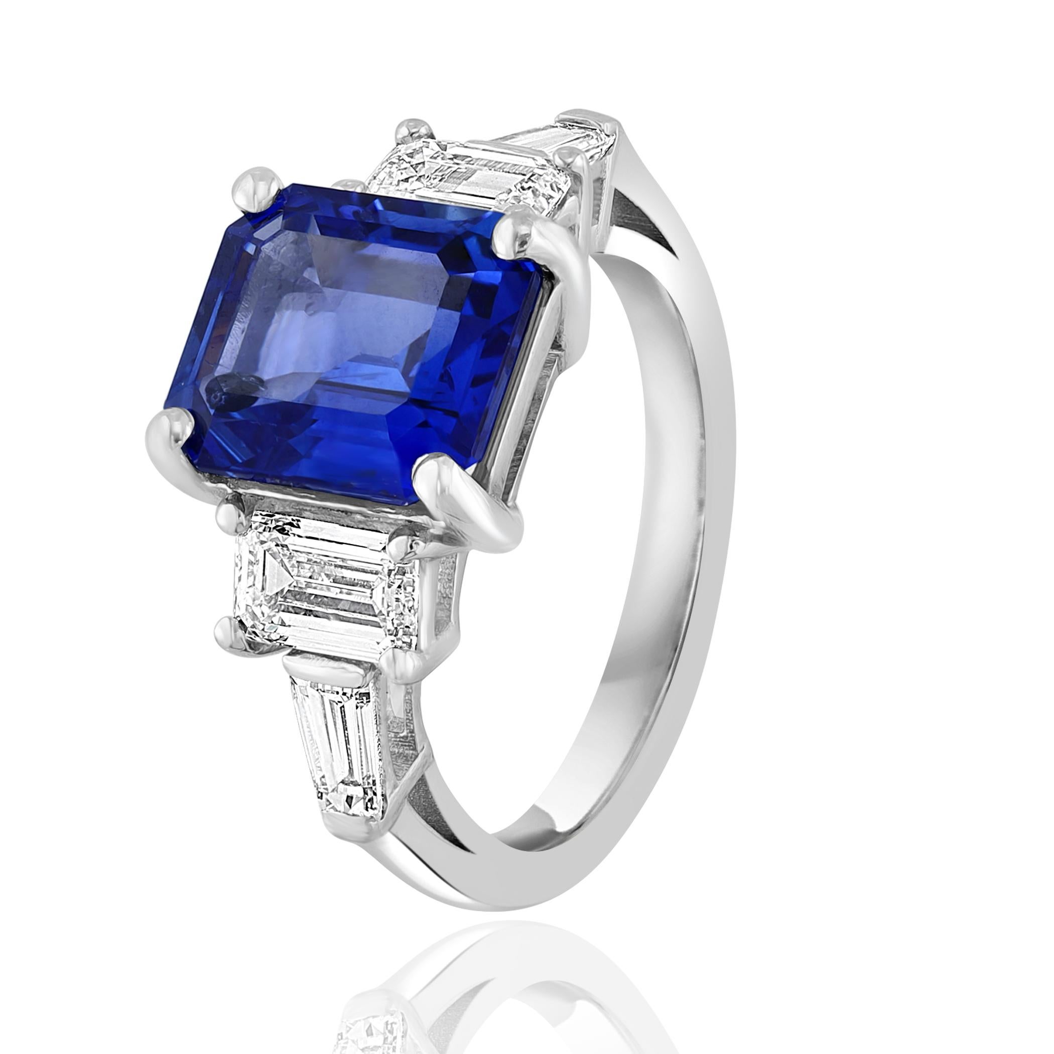 Showcasing color-rich 4.74 carat Certified Blue Sapphire. Two perfectly matched GIA Certified emerald cut diamonds weighing 1.05 carat elegantly flank the center emerald cut blue sapphire for a very classy and sophisticated piece. Additional 2