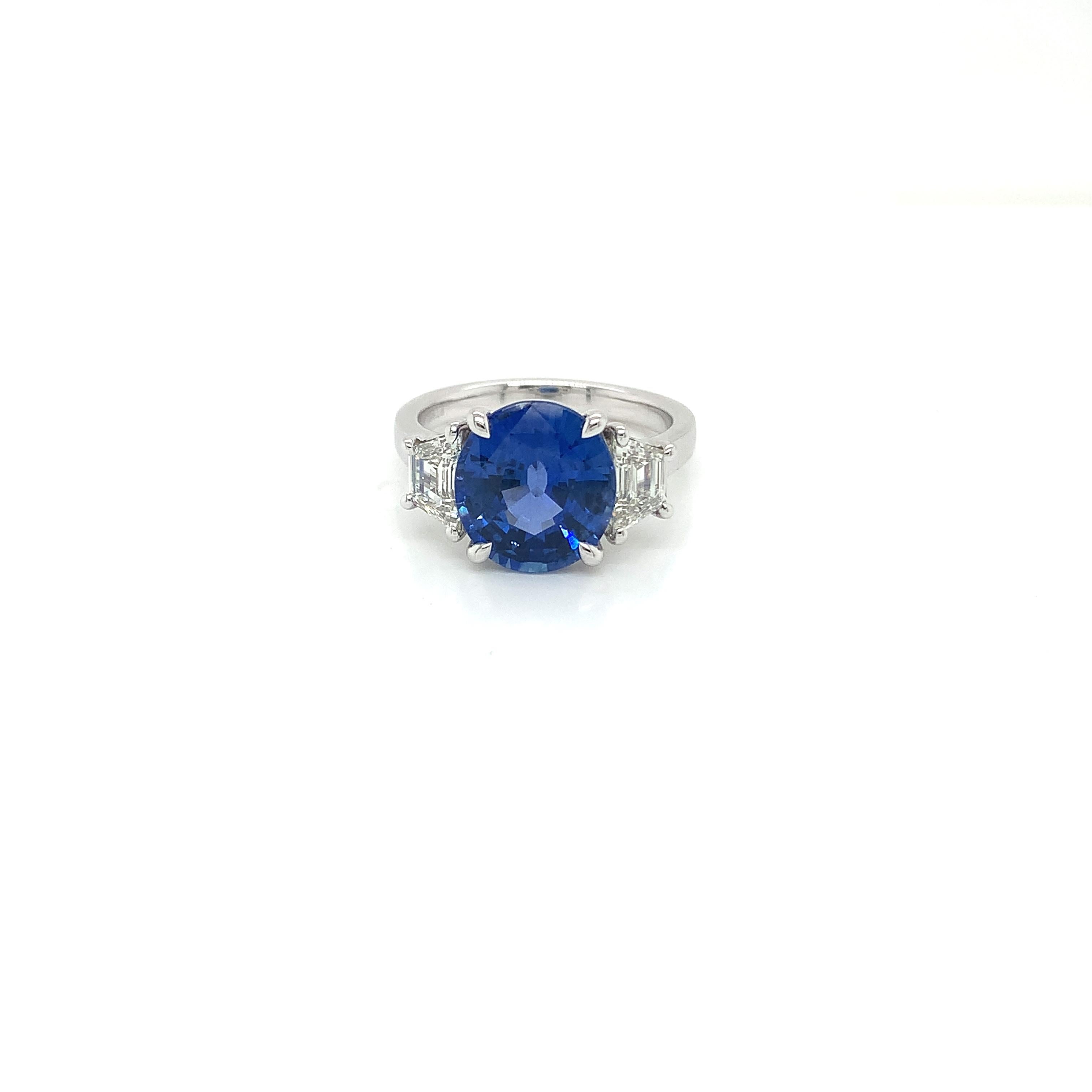 Certified Oval Ceylon Sapphire weighing 5.00 cts
Measuring (10.93x9.90x5.93) mm
2 Trapezoid diamonds weighing .86 cts
Measuring (6.4x3.6) mm
Set in Platinum ring


