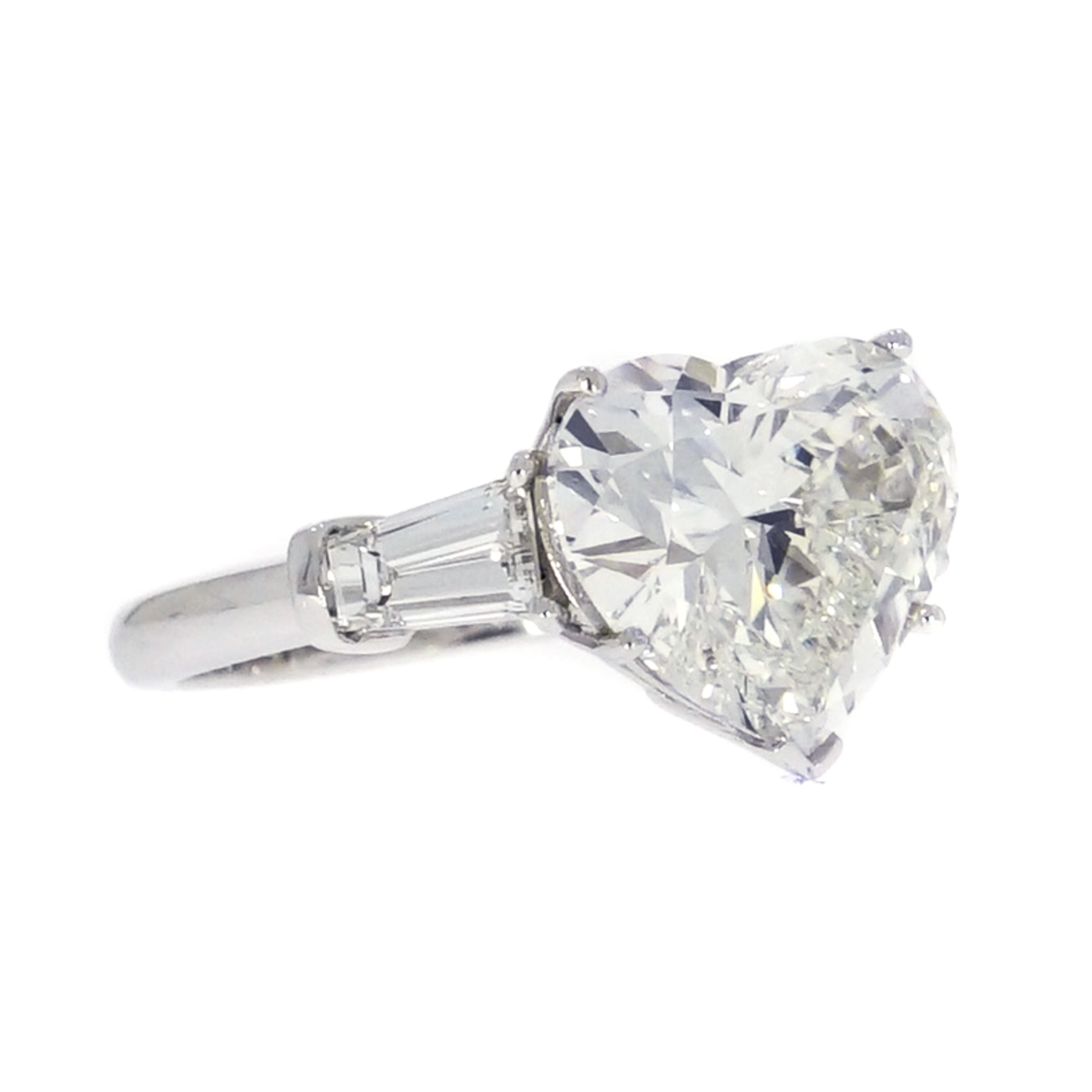 Make her heart skip a beat with this Gorgeous 5.02 carats Heart Shaped Diamond Engagement Ring.
Handcrafted in Platinum with a tapered baguettes at each side (1.01 ct.).
Finger Size 6
The heart shaped diamond is certified by EGL as G color, VS2
