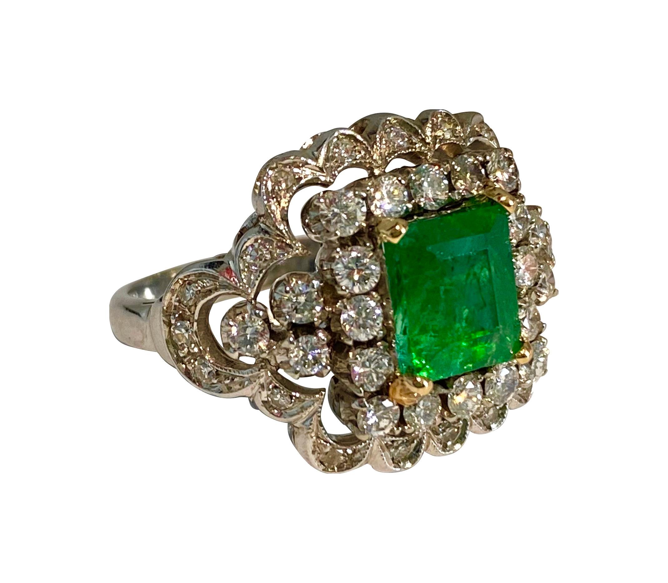 Metal: 18k white gold. Diamonds: 2.05 carat weight total, VS clarity and F color, round brilliant cut set in prongs. 
Emerald: 3.00 carats, deep saturation and color. 
Total carat weight of all precious gemstones: 5.05 carats. 
All precious stones