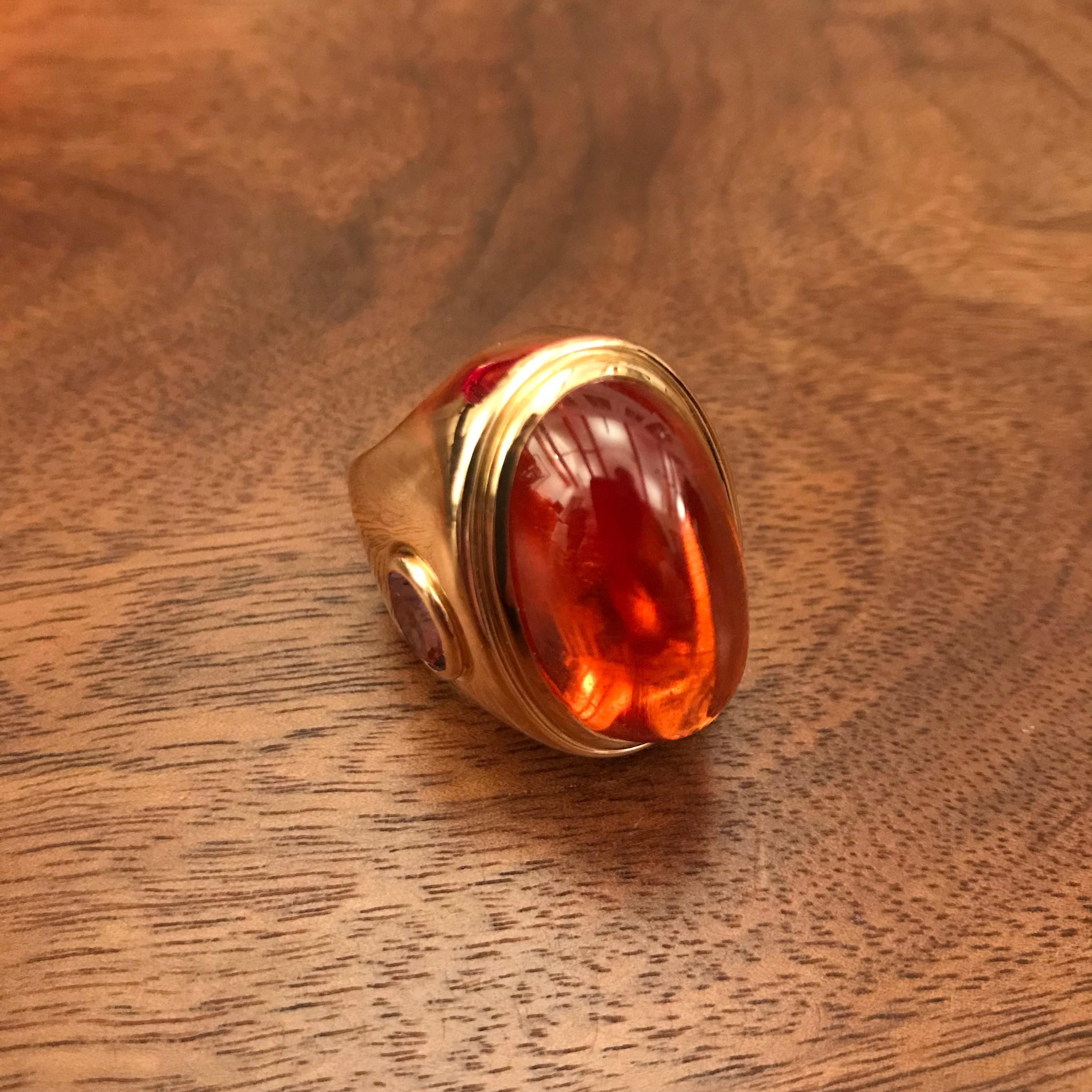 An eye-catching piece. 18 carat rose gold cocktailring. With an unique Mandarine-Garnet 51.21 ct and 2 Amethysts 2.41 ct in all. The Ring has been designed and handcrafted by Colleen B. Rosenblat in our atelier in Hamburg. The Ringsize is EU 56 = US