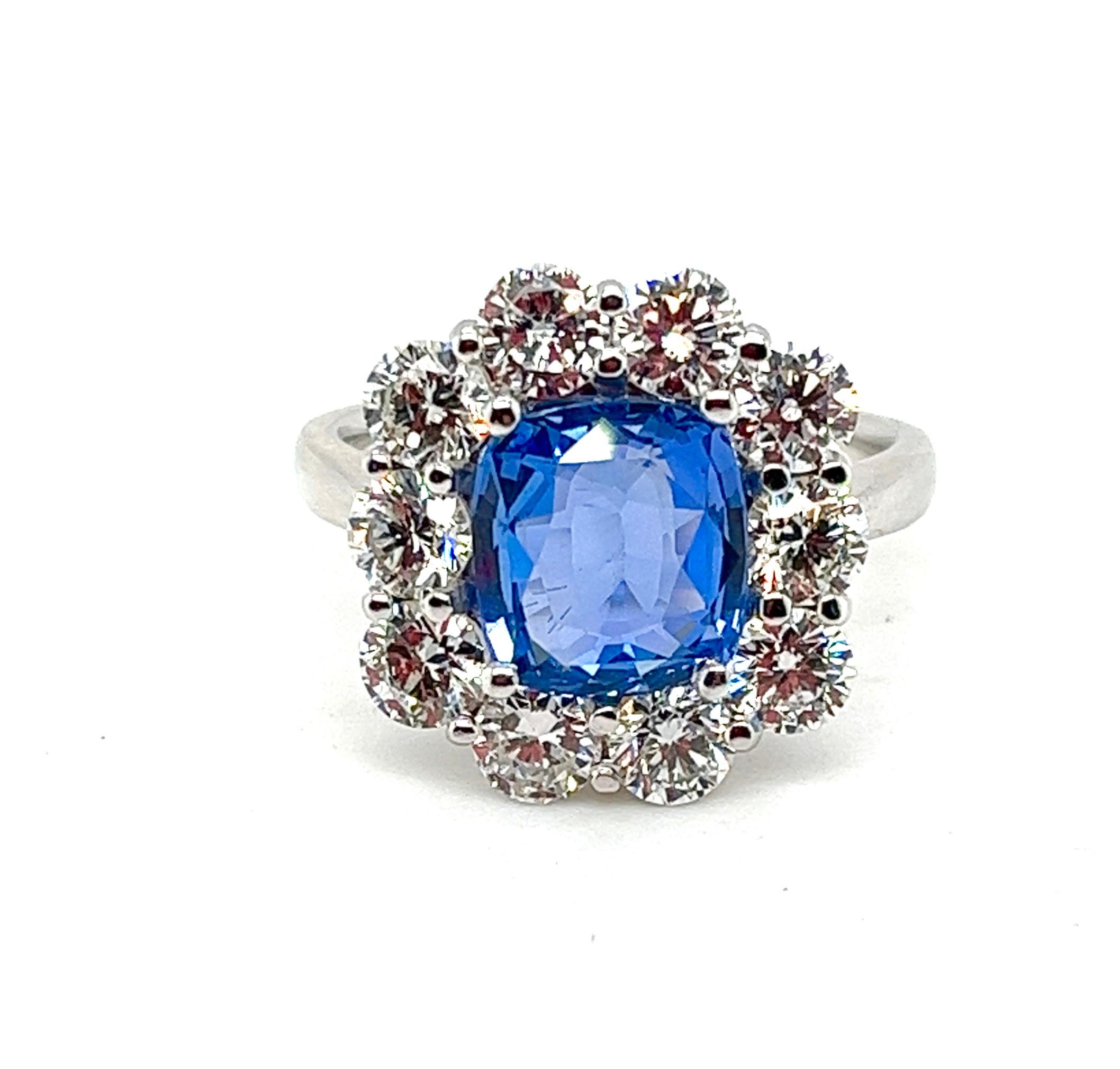Exquisite 18K White Gold Blue Sapphire and Diamond Cocktail Ring

Unveil the epitome of opulence with our breathtaking cocktail ring, a symphony of natural beauty and masterful craftsmanship. At its heart lies a captivating cushion mixed-cut blue