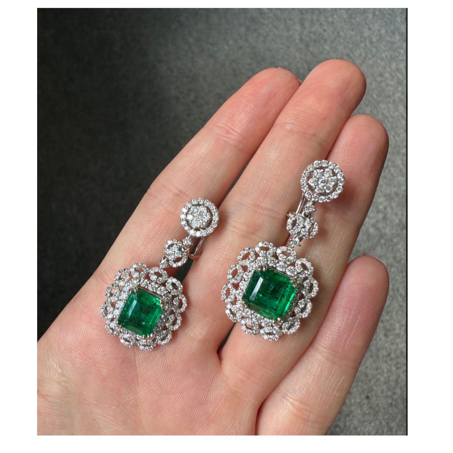 A stunning pair of natural Zambian Emeralds, set in an exquisite mount using 3.43 carat VS/SI F/G White Diamonds, all set in solid 18K White Gold. Comes with omega clips. 