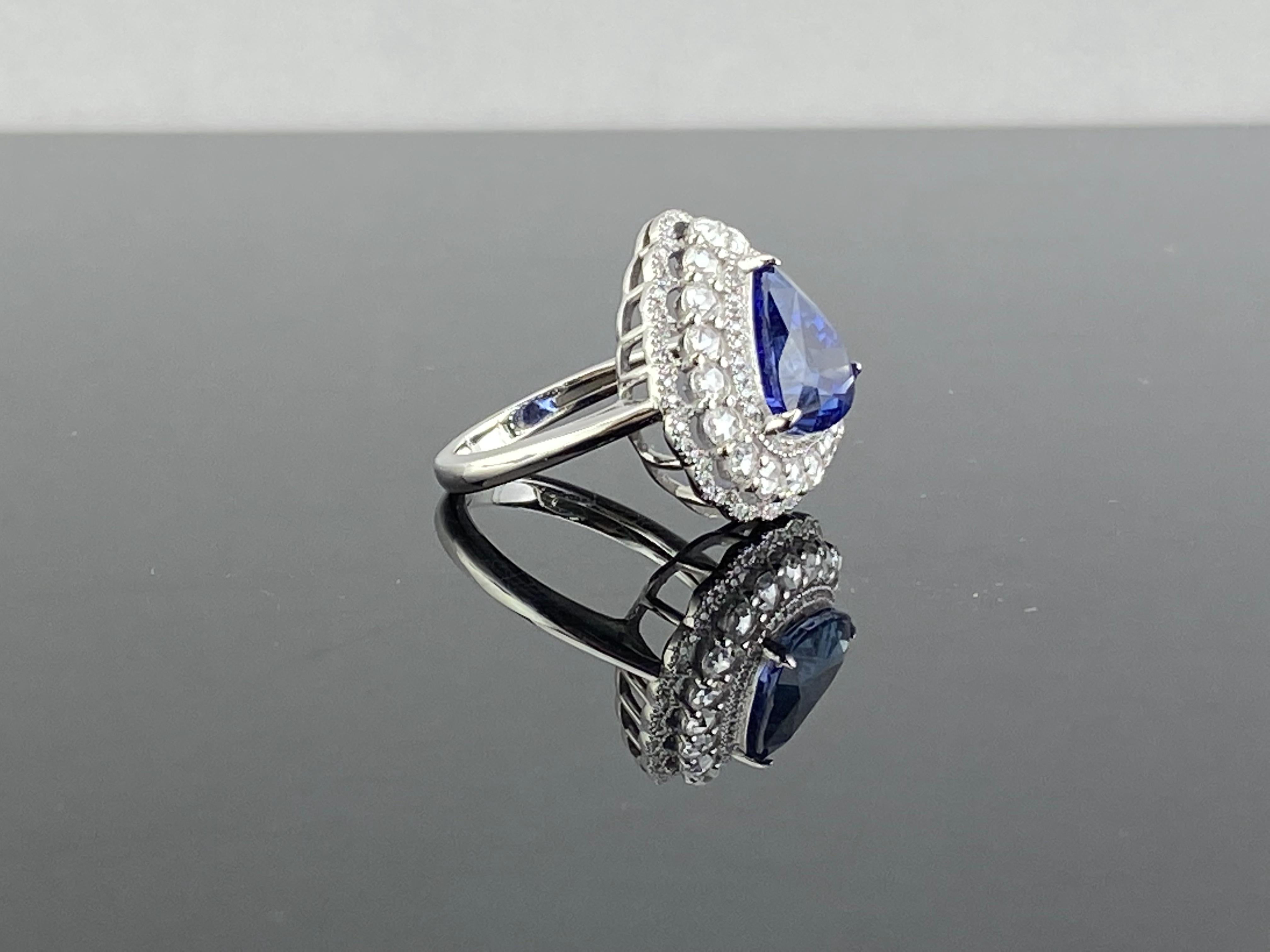 A one of a kind, 5.30 carat pear shaped, royal blue, Sri Lankan Blue Sapphire - absolutely transparent with no inclusions, great color and luster, surrounded by full cut and rose cut White Diamonds, all set in solid 18K White Gold. Currently sized