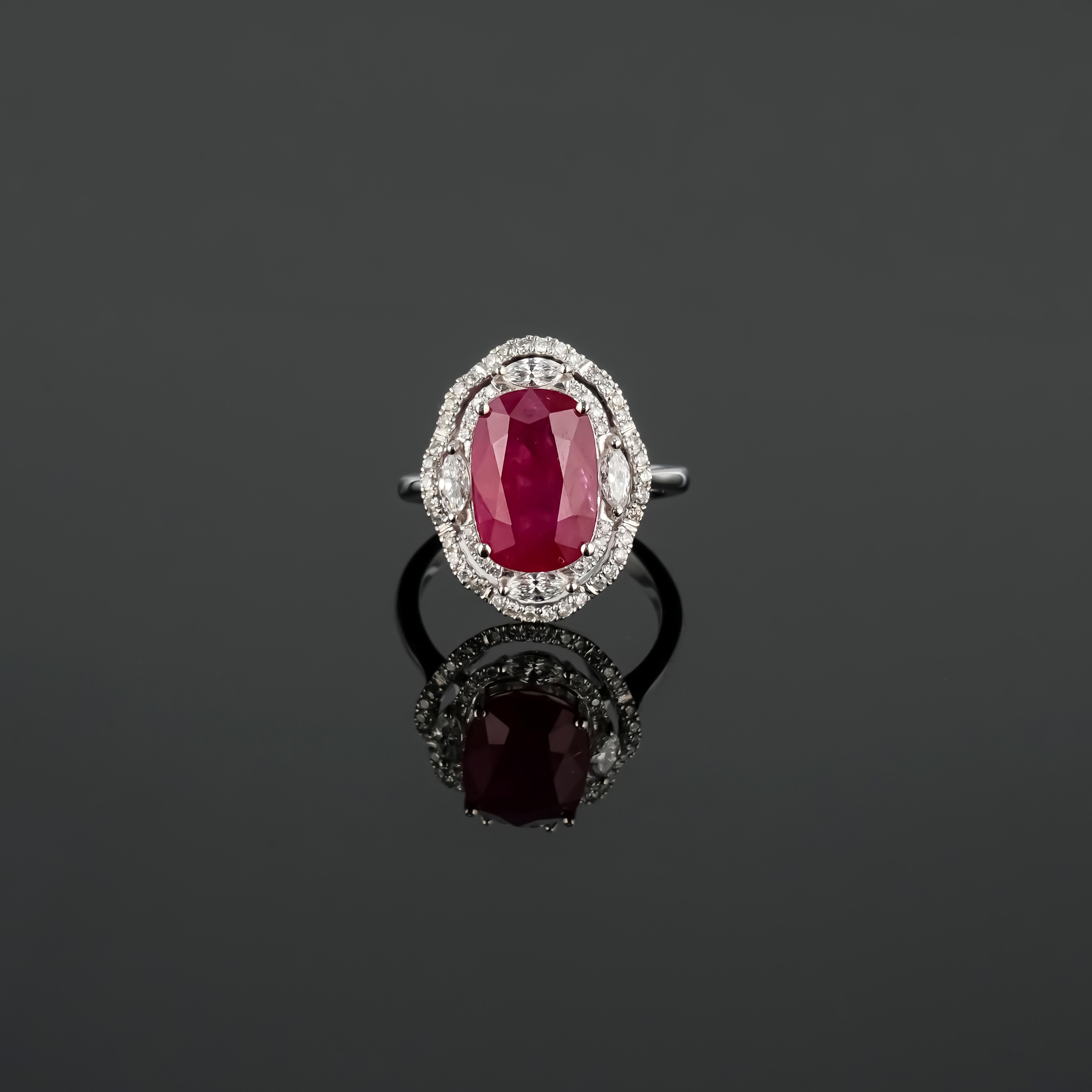 A stunning, certified, vivid red 5.40 carat Burmese heated Ruby and Diamond ring, set in 18K White Gold. The ring is currently sized at US size 7, and can be resized. The color of the center stone is ideal, and has great luster and is transparent.