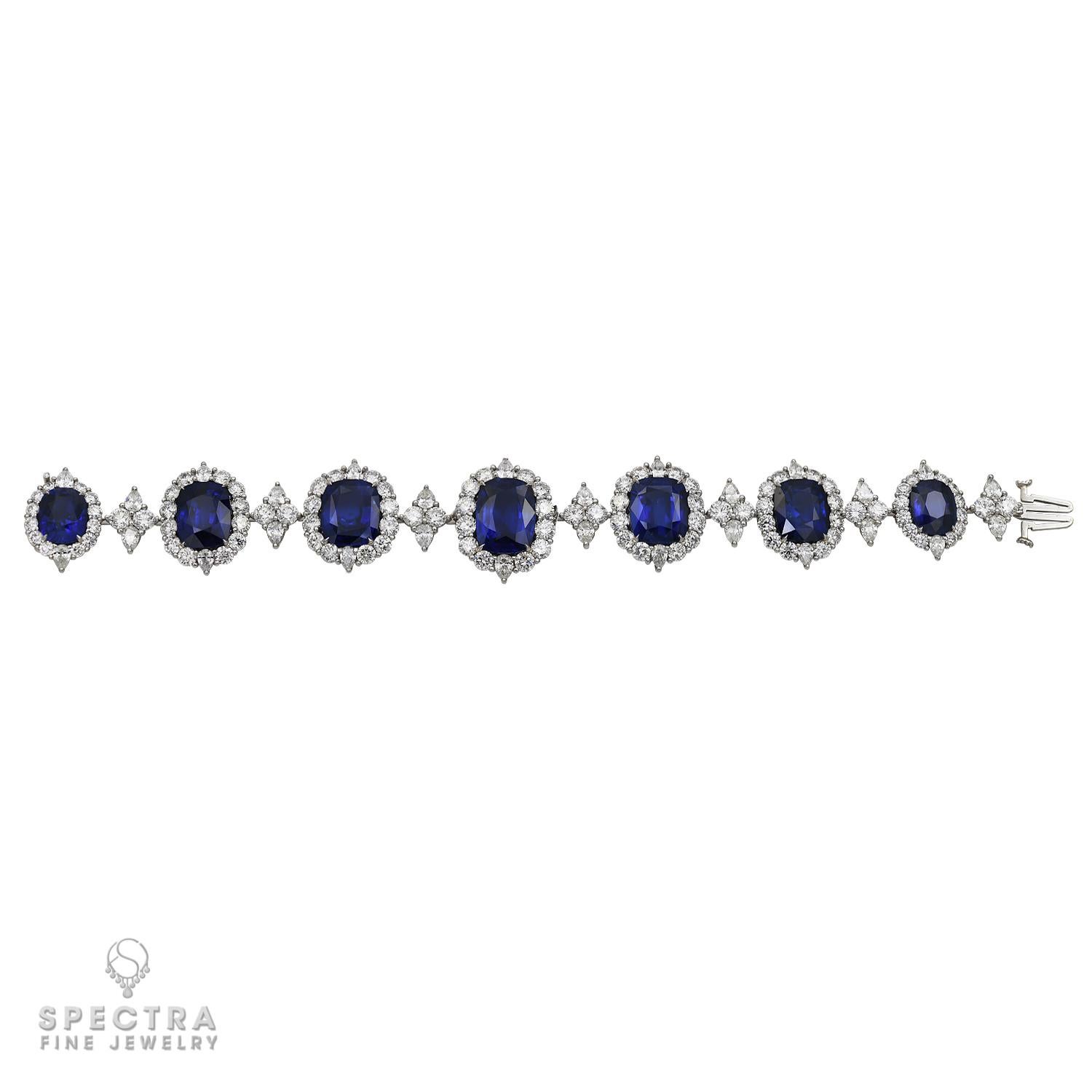 This Contemporary Sapphire Diamond Riviere Bracelet, made by Spectra Fine Jewelry in the 21st century, circa 2018, is crafted in platinum and features 7 cushion-cut Ceylon sapphires, weighing approximately 54.36 carats total. Five of the seven